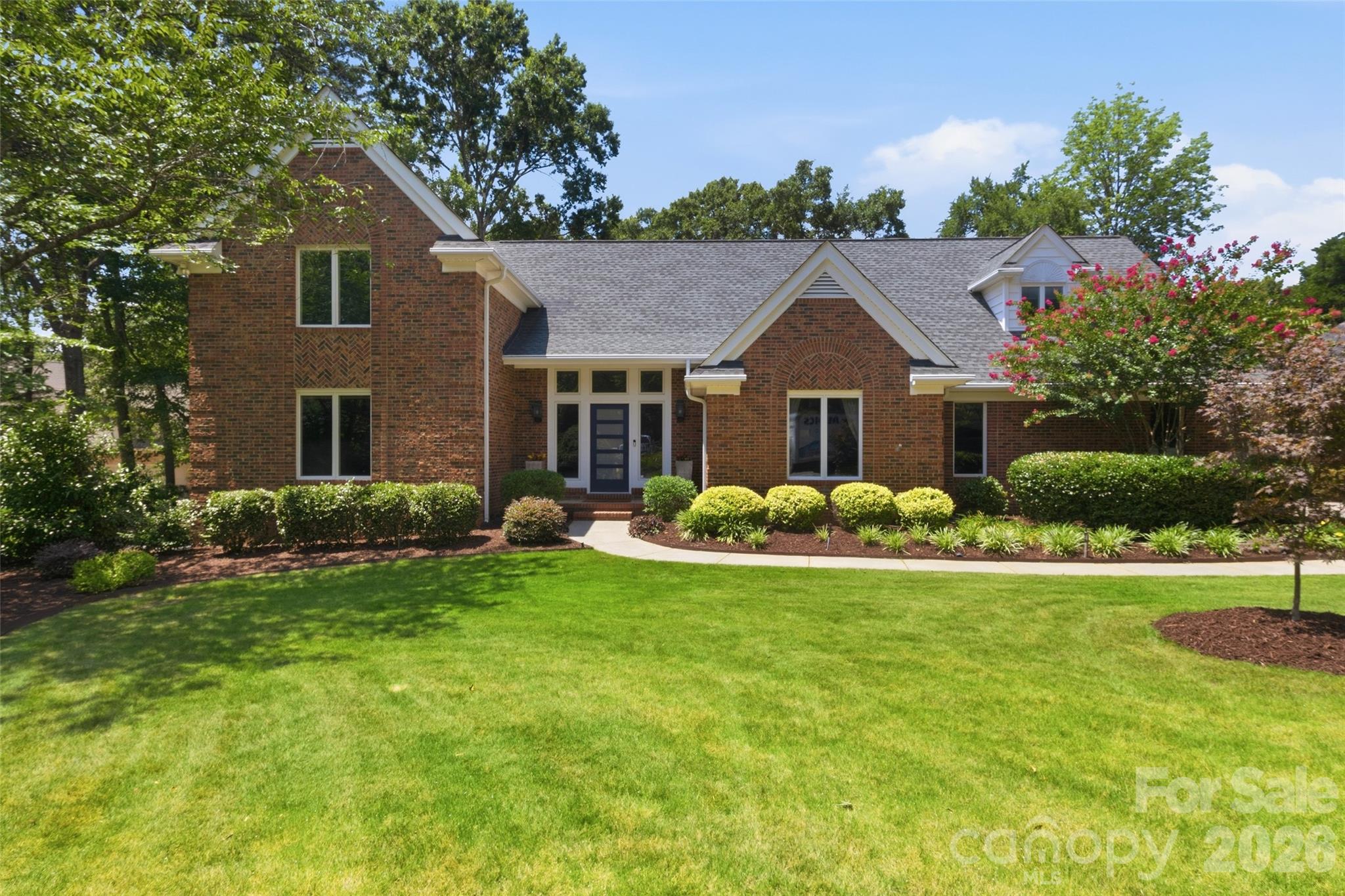 Tucked away on a picturesque .62-acre cul-de-sac homesite in highly desirable Ardrey Acres, this beautifully maintained full brick home offers timeless character, thoughtful updates and upgrades over the years, and exceptional versatility. Surrounded by lush, mature landscaping, the setting is both private and inviting.

Inside, you'll discover custom architectural details throughout, complemented by an updated kitchen with modern appliances and beautifully renovated baths. The spacious main level features a sought-after primary suite along with an additional guest bedroom and full bath, offering ideal flexibility for guests or multigenerational living.

Designed for both everyday comfort and entertaining, the home offers a light-filled sunroom overlooking the scenic backyard, a Trex deck for outdoor gatherings, and generous living spaces throughout. Upstairs you'll find two additional bedrooms plus a massive bonus room that easily serves as a fifth bedroom, media room, playroom, or home office.

Car enthusiasts, hobbyists, or those needing extra storage will appreciate the attached two-car side-load garage along with a detached garage complete with workshop and storage space.

Located just minutes from Historic Downtown Fort Mill, the Hwy 521 corridor, Ballantyne, South Charlotte, premier dining, shopping, and recreation, this exceptional home combines peaceful living with unbeatable convenience. Enjoy award-winning Fort Mill schools, low South Carolina taxes, and one of the area's most sought-after communities. This is the one you've been waiting for!
