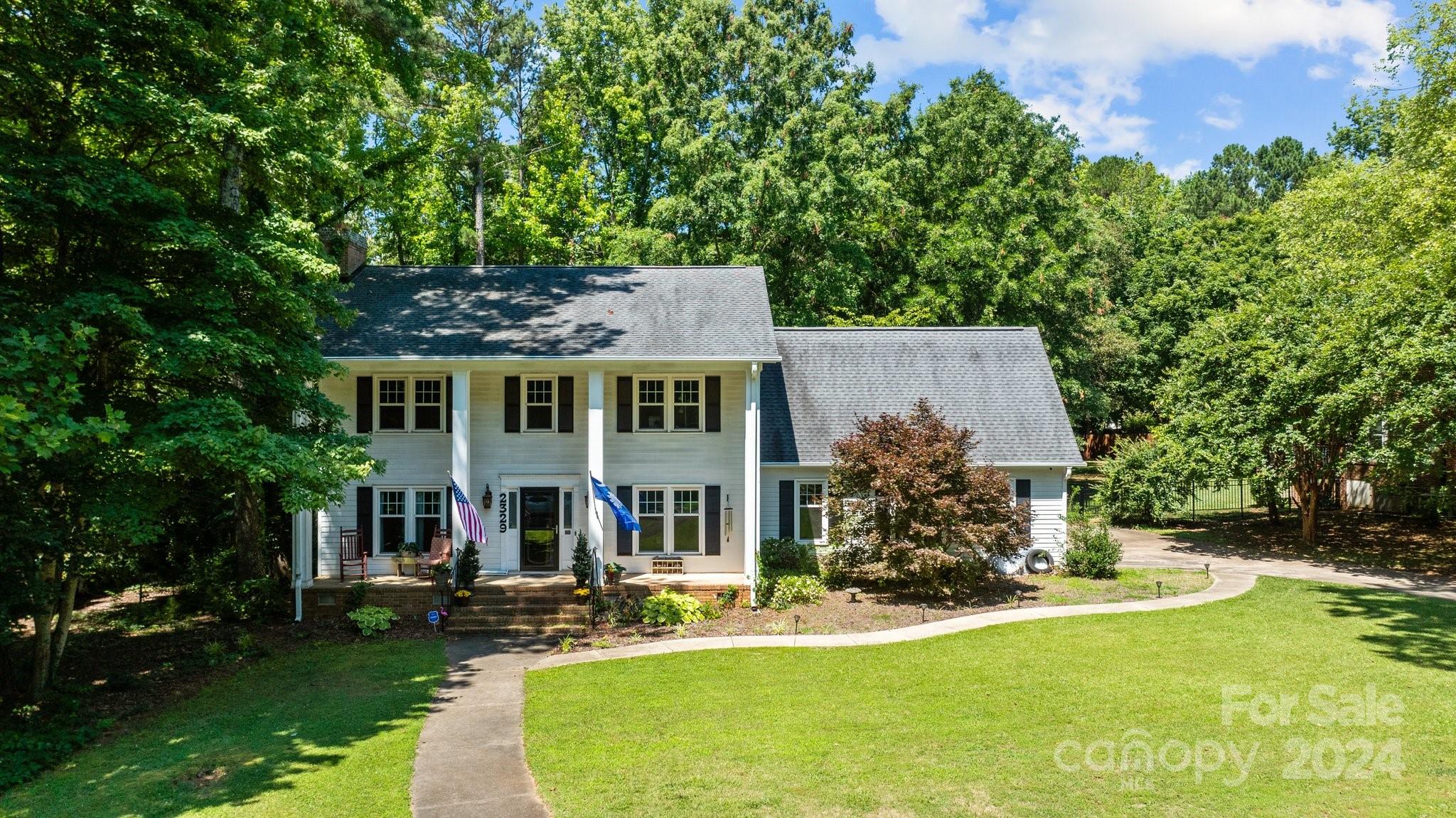 Welcome to 2329 Raven Drive... the perfect blend of timeless elegance and modern convenience. Graced with traditional charm, the home features a classic center hall layout, providing a seamless flow between the living spaces. Boasting 4 bedrooms, 2.5 baths, and a unique generational living guest suite with a private entrance, this home is designed to accommodate a variety of lifestyles. Ideal for multi-generational families or hosting guests, the guest suite features a separate living area, bedroom, kitchen, and laundry facilities, providing privacy and comfort. Situated on a beautiful wood-lined lot, the property offers tranquility and privacy, creating a serene oasis for outdoor enjoyment. Enjoy the sense of community and convenience of living in the established Rawlinson Acres II neighborhood with tree-lined streets and a welcoming atmosphere.