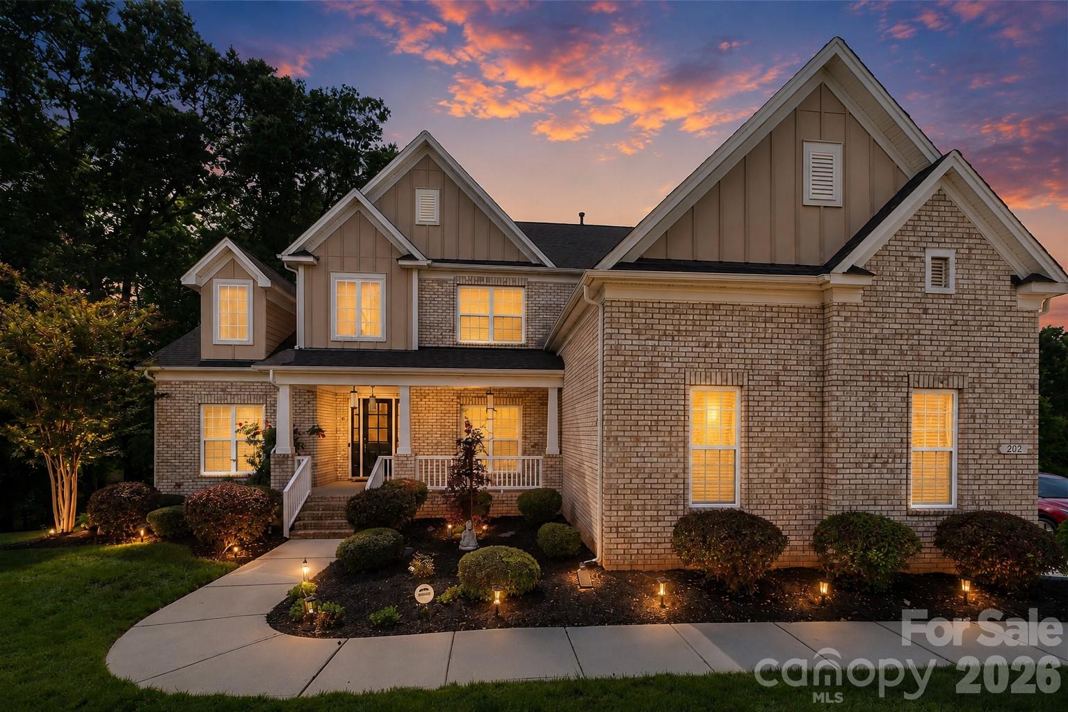 Welcome to this stunning move-in ready full-brick home situated on a quiet cul-de-sac in one of Waxhaw's most desirable communities. Recently refreshed with fresh interior paint, polished flooring, and professionally cleaned carpets, this beautifully maintained residence offers an exceptional blend of luxury, comfort, and functionality.

The open-concept floor plan features a dramatic two-story family room with soaring ceilings and abundant natural light. The chef's kitchen is designed for entertaining with quartz countertops, upgraded cabinetry, stainless steel appliances, and an oversized center island that serves as the heart of the home. The main-level primary suite provides convenience and privacy, while elegant tray ceilings add architectural character throughout.
Upstairs, you'll find spacious secondary bedrooms, including a unique bedroom with a built-in alcove perfect for a library, study area, or creative space. The upper level also features a dedicated home theater room with immersive 7.2.2 surround sound, plus a separate game/media room with 5.1 theater wiring, offering incredible flexibility for entertainment and recreation.

Step outside to enjoy a covered, extended deck with integrated speakers overlooking a private wooded backyard with beautiful sunset views. A custom stone-paved patio with a firepit creates the perfect setting for relaxing evenings and outdoor gatherings.

Additional updates and features include new HVAC systems, new water heater, new dishwasher, upstairs and downstairs laundry connections, two attic spaces, crawl space storage, and abundant storage throughout.

Community amenities include a clubhouse, swimming pool, basketball court, tennis courts, playground, and scenic wooded walking trails along a creek. Combining luxury finishes, modern updates, exceptional entertaining spaces, and resort-style amenities, this home offers a rare opportunity to enjoy the very best of Waxhaw living.