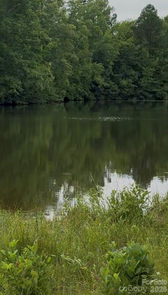 Beautiful lot to build your dream home on.  The entire front of the lot is on a shared pond with no neighbors close by.  This lot is very secluded on a cul-de-sac and down a long drive to the water.  There is a single wide mobile home that needs alot of work and is conveyed as is.  There is a well and septic on the property.  Come be one with nature and check this beauty out before it's gone.