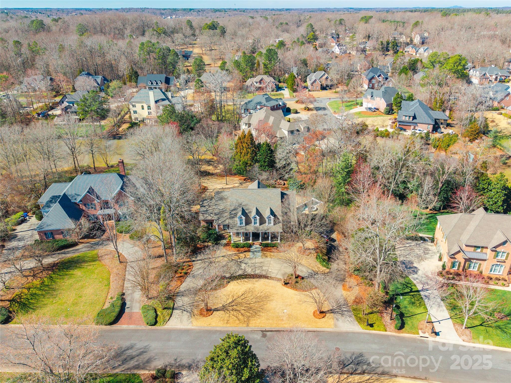 This impressive custom-built, all-brick home features six bedrooms and five and a half bathrooms on a one-acre lakefront lot in the sought-after Lake Meadow II community. A covered front porch with stately columns enhances its exceptional curb appeal. Inside, reclaimed barn wood hardwood floors add character and warmth. The finished basement offers additional living space, including a bonus room, a full bath, and an exercise room. In the backyard, a covered porch and an upper-level balcony provide views of the spacious backyard and the show stopping in-ground pool with a cascading waterfall. This remarkable property offers a rare blend of elegance and space in a beautiful setting.