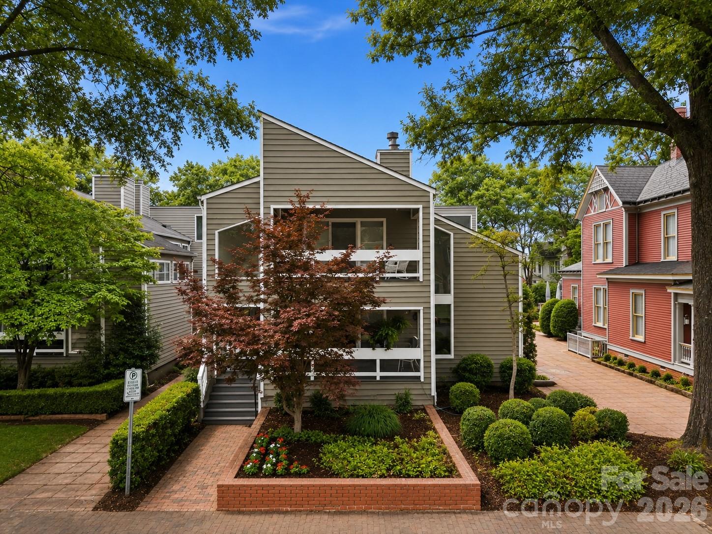 Tucked within Charlotte’s historic Fourth Ward, this architecturally distinctive residence offers a rare blend of intentional design, natural light, privacy, and exceptional indoor-outdoor living. Thoughtfully crafted with timeless modern influences, the home delivers an elevated living experience deeply connected to its surroundings.

Expansive windows, soaring architectural lines, and light-filled interiors create a warm and inviting atmosphere throughout the home. The thoughtfully designed layout balances sophistication and comfort, offering seamless spaces for both quiet retreat and large-scale entertaining.

The main living areas transition effortlessly onto the expansive front porch, side deck, and private rear courtyard, offering creating multiple outdoor spaces for dining, gathering, and relaxation while overlooking beautifully landscaped grounds. A dedicated library a with gas log fireplace on the main level provides a refined setting for reading, working from home, or creative pursuits, adding both charm and functionality to the home.

The private backyard is a true rarity in Uptown Charlotte, featuring an in-town tennis court that transforms the property into an exceptional urban retreat.

Designed for entertaining, the expansive lower level features a built-in bar and generous flexible living space ideal for hosting guests, game nights, media viewing, recreation, or additional lounge areas. The open layout flows seamlessly to a private courtyard, creating an effortless indoor-outdoor experience perfect for both intimate evenings and larger gatherings.


The primary suite serves as a true private retreat, offering privacy, comfort, and thoughtfully designed bonus spaces rarely found in Uptown living. Just off the primary bedroom, a separate flex room provides the perfect setting for a private office, wellness space, creative studio, dressing room, or craft room tailored to your lifestyle needs.

Connected to the primary ensuite, a tucked-away loft-style reading nook creates a quiet and unexpected escape ideal for reading, relaxing, reflection, or simply unwinding away from the main living spaces. This intimate hideaway adds a distinctive architectural element that makes the suite feel both personal and unforgettable.

Throughout the residence, intentional architectural details, natural materials, and abundant natural light create a refined yet welcoming environment designed for both everyday living and memorable entertaining.

Located moments from Fourth Ward Park, Uptown dining, entertainment, cultural venues, and Charlotte’s business district, the home offers exceptional convenience while preserving the character and charm of one of Charlotte’s most established neighborhoods.

An additional opportunity exists to purchase the neighboring property at 515 N. Poplar in conjunction with this residence, creating expanded possibilities for multi-property ownership, guest accommodations, investment potential, or additional living space.

Both sellers prefer to sell the residences together with a combined offering price of $3.5 million.