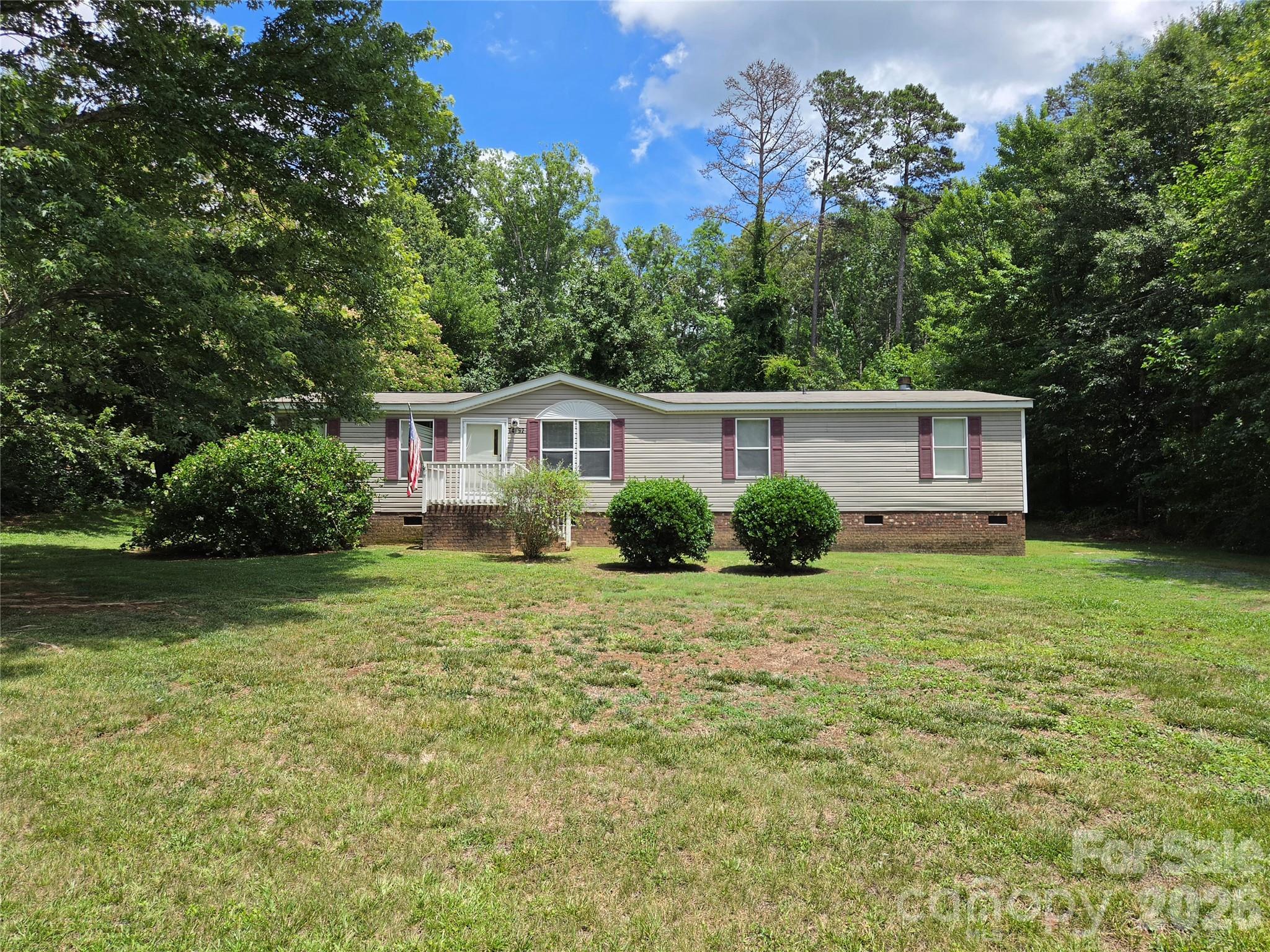 Home is located in a rural subdivision, centrally located to multiple cities and town and would be a great home as an investment property or good for those starting out or downscaling! The home sits on a corner lot, buffered by trees on the back and sides, and offers a spacious back yard with room for a garden, pool and detached building or garage.  New roof in 2025.  New AC 9/2021 and Vinyl Plank flooring installed in kitchen, laundry and primary bathroom.   Most of flooring needs to be replaced and home needs new paint along with some repairs and remodeling.
