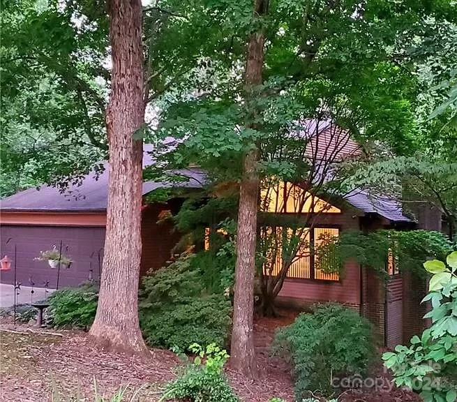 Beautiful 3 bd, 2 ba home nestled among the trees on a very private lot. This home backs up to hole number 12 only steps away from the backyard. Light and bright family room with vaulted ceiling opens up to the dining area also with vaulted ceilings.  Kitchen has been remodeled with white cabinets, granite countertops and stainless steel appliances. Two spacious bedrooms and full bathroom round out the first floor. The Master suite on the second floor is its own private sanctuary with a separate office, walk in closet and additional huge closet.  Master bath has double sinks, whirlpool tub and separate shower. As a bonus space, the basement although not heated,  has been made into an office and secondary family space. Swimming pool and tennis/golf memberships are available as well as a public lake access less than 5 min away for boating and water sports. Close proximity to hwy 74 making it an easy commute to Charlotte.
