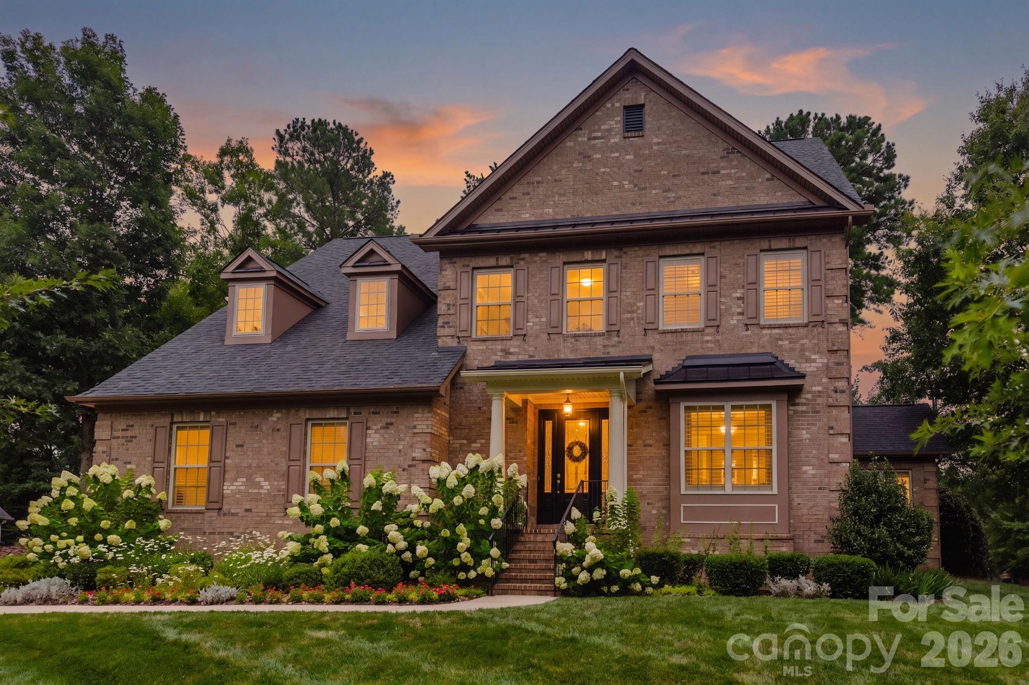 Nestled on a premium corner cul-de-sac lot surrounded by mature trees, this exceptional 5-bedroom, 4-bath home offers over 3,800 square feet of thoughtfully designed living space in the sought-after Preservation Pointe community. Enjoy the perfect balance of elegance, comfort, and privacy just moments from Mountain Island Lake.

The heart of the home is a beautifully appointed chef's kitchen featuring an oversized island with seating, granite countertops, gas cooktop, double wall ovens, abundant cabinetry, and a walk-in pantry. The kitchen opens seamlessly to the spacious great room with a gas fireplace, creating an ideal setting for both everyday living and entertaining. A formal dining room, sunlit breakfast area, welcoming foyer, and convenient drop zone complete the main level.

The main-floor guest suite with a full bath provides the perfect space for overnight guests or multigenerational living. Upstairs, the spacious primary retreat features a tray ceiling, spa-inspired bath with dual vanities, soaking tub, walk-in shower, and an oversized walk-in closet. Three additional bedrooms, two full baths, a large bonus room, and an upper-level laundry room provide exceptional flexibility for today's lifestyle.

Outdoor living is equally impressive. Relax on the covered deck overlooking the private, fenced backyard surrounded by mature trees, or entertain on the beautifully landscaped paver patio below. The half-acre corner lot offers an uncommon level of privacy while still being part of one of northwest Charlotte's most desirable neighborhoods.

Additional features include hardwood flooring throughout the main living areas, a two-car newly epoxied garage, new roof, zoned HVAC, irrigation system, security system, surround sound, and abundant storage.

Residents of Preservation Pointe enjoy outstanding amenities including a community pool, playground, picnic area, RV storage, sidewalks, and lake access, all with convenient access to Mountain Island Lake, Charlotte Douglas International Airport, Uptown Charlotte, shopping, dining, and major highways.