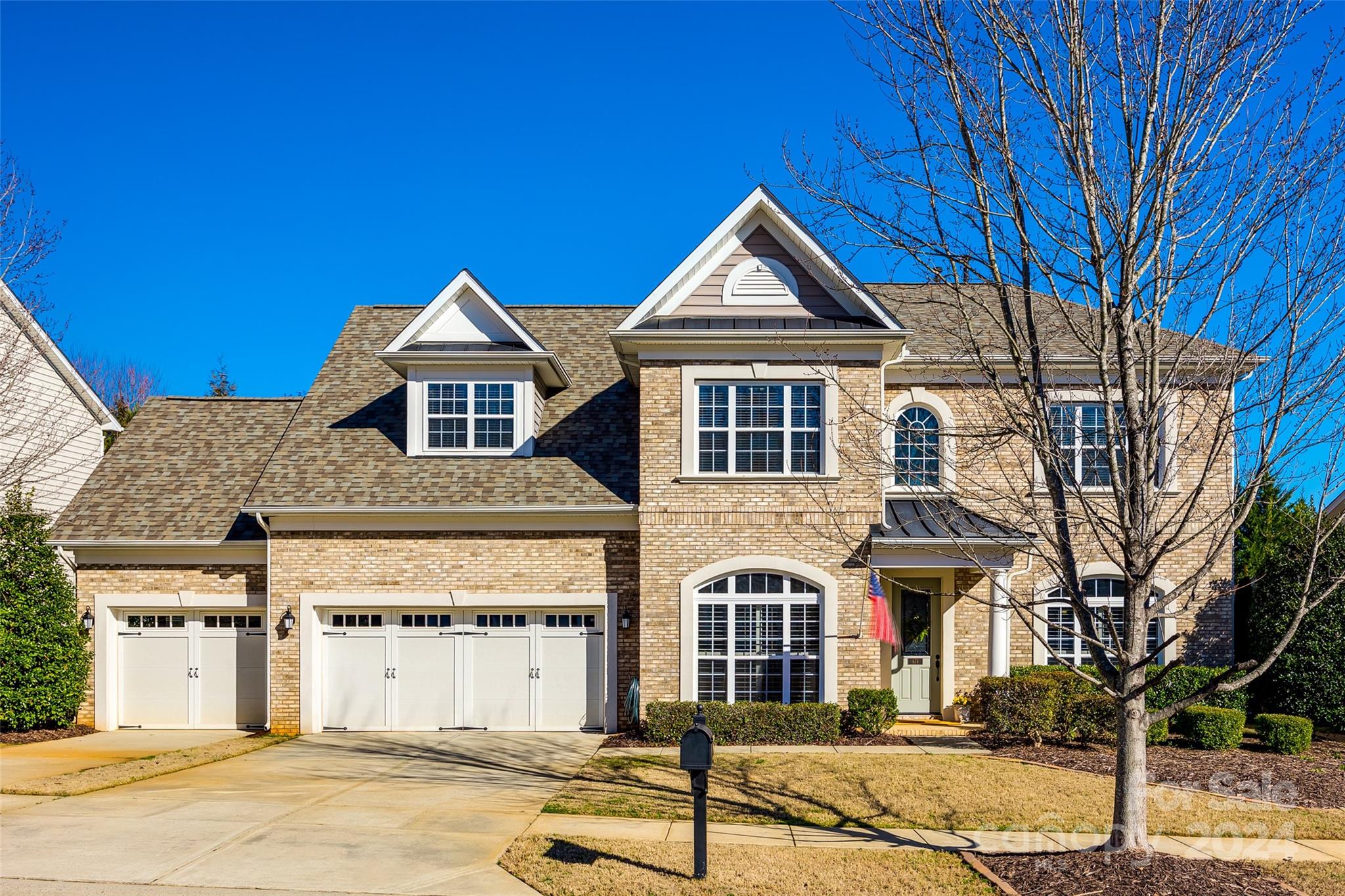 FORT MILL...The Reserve at Gold Hill...Welcome to this beautiful move-in ready home featuring an abundance of architectural details: 10-12’ ceilings, tray ceilings, 8’ doors, crown molding, wainscotting, arched windows, and shutters. Hardwood floors in main living areas. With a desirable main floor office, gourmet kitchen with granite, double oven, and cooktop, the island is perfect for entertaining. Relax in the great room by the cozy fireplace with beautiful backyard views. Primary suite on the main level with double tray ceiling, "closet by design" walk-in closet, ensuite with soaking tub, tiled shower, and double sink vanity. Convenient main floor laundry room w/cabinets. Second level w/Loft, beds 2 & 3 share jack/jill bath, bed 4, bonus/bed 5, all w/walk-in closets, & another full bath. Fully fenced backyard w/paver patio, 3 car garage w/epoxy floors & utility sink. Neighborhood amenities include a pool, clubhouse, airnasium, pickleball court, playground & recreation area.