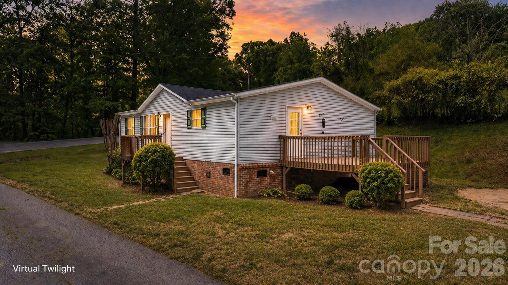 Private and move-in ready 3BR/2BA home situated on 1.2 wooded acres offering space, flexibility, and a peaceful setting just outside of town. This home features an open living area, large kitchen with abundant cabinet space, stainless range, ample countertop workspace, and a dedicated dining area perfect for everyday living.

The spacious primary suite includes a large ensuite bath with double vanity, garden tub, separate shower, and generous closet space. Fresh, clean interiors with updated flooring and neutral finishes make it easy for the next owner to move right in and make it their own.

Enjoy outdoor living with both front and side decks, ideal for relaxing, grilling, or entertaining while overlooking the wooded surroundings. The oversized lot offers additional parking, flexibility, and potential for future use.

Conveniently located just minutes from Drexel, Morganton, local schools, shopping, dining, and easy access to I-40 and Highway 70, this property offers both privacy and everyday convenience.

A great opportunity for primary living, rental investment, or a peaceful mountain-area getaway.