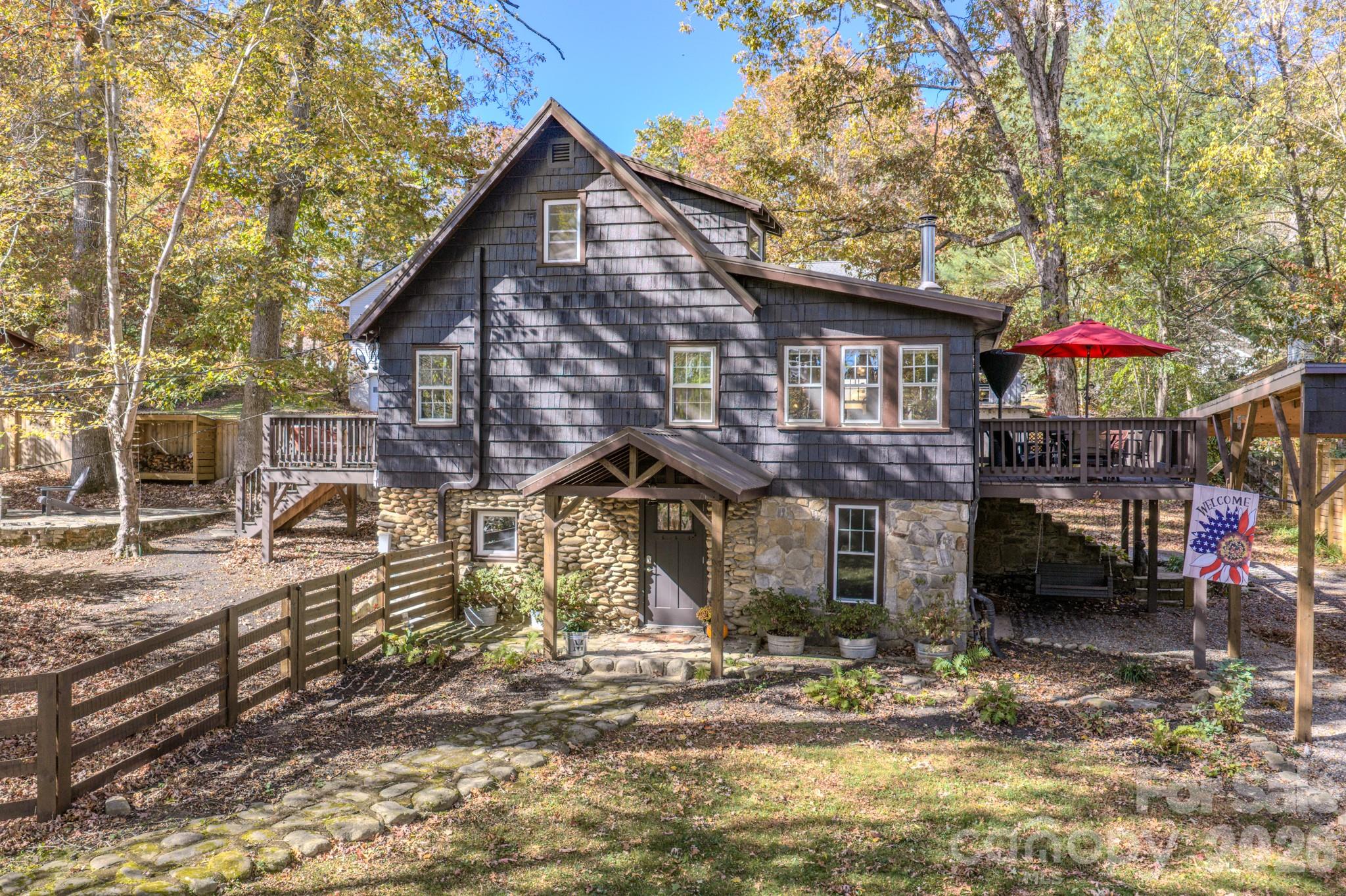 Experience timeless charm and modern comfort in this beautifully updated, historically preserved home just steps from Lake Tomahawk and downtown Black Mountain. Situated on one of the largest lots in the neighborhood, this property offers room to expand or build additional structures with a separate lot on water and sewer—a rare find in such a desirable location.
Inside, you’ll find 3 bedrooms and 2.5 baths (spacious loft room not included- so really 4 sleeping spaces), featuring thoughtfully curated updates throughout. Recent improvements include newly restored and painted cedar siding, new porch door portico, a new laundry room, new walls and doors on the lower level, new exterior doors, fence, radon mitigation system, RV hookup, RV/car port and a new dishwasher—all completed within the past year. In recent years, nearly every aspect of the home has been refreshed, including Bosch dual built-in ovens, kitchen countertops, refinished floors, and much more. 
Enjoy the mountain air on two side porches, unwind by the private stone patio and fire pit, or relax in the fenced side yard for added privacy. Circle drive make creates convenience for parking. The property also includes a large storage shed/workshop with electrical service that could be plumbed for another living space, plus the RV parking with electrical hookup—perfect for guests or travel enthusiasts.
With smart exterior lighting, thoughtful upgrades, and furnishings negotiable, this home is ideal as a primary residence, second home, or ideal STR/ income-producing investment. Currently listed as STR so showing maybe limited.