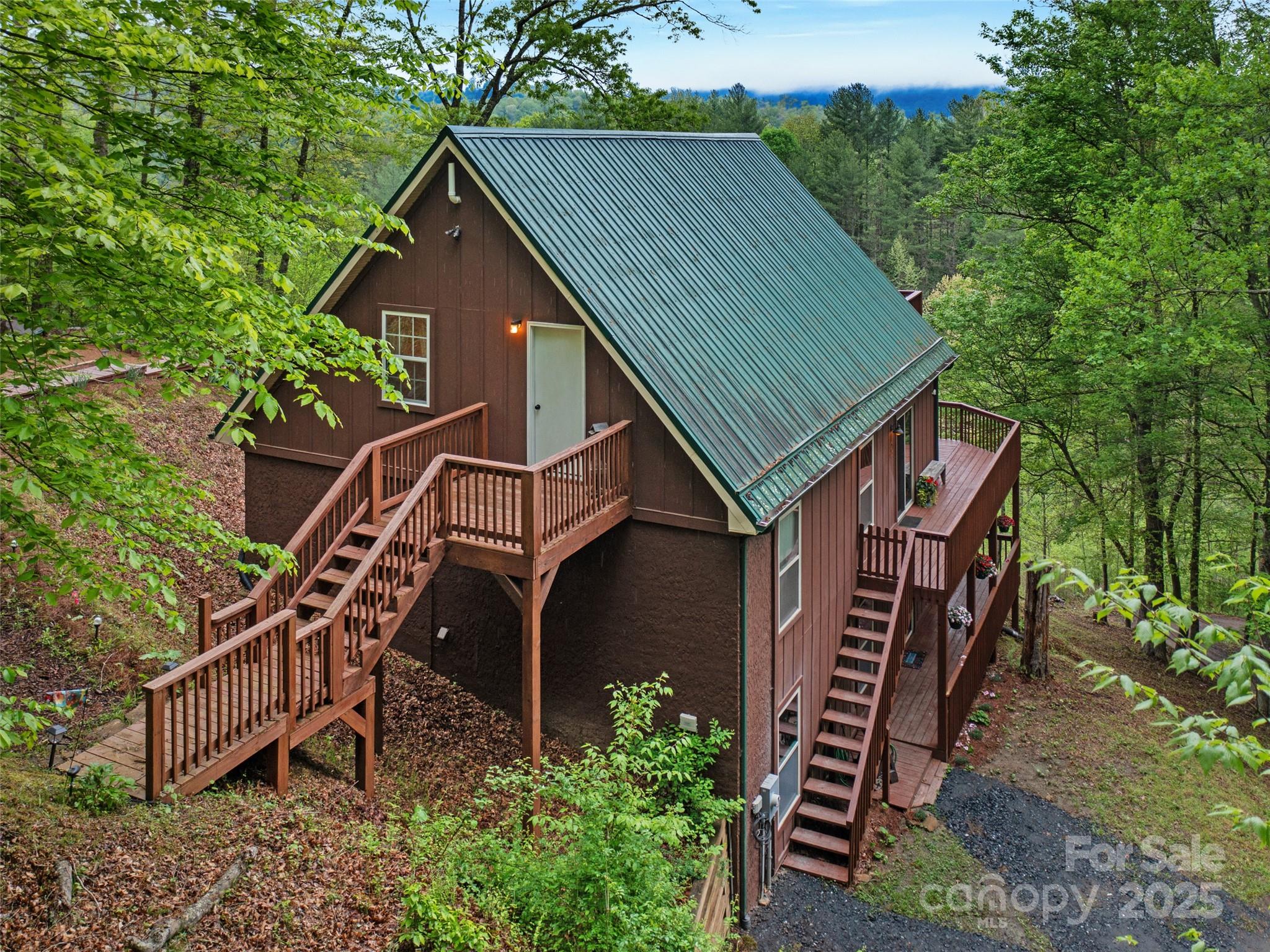 STUNNING VIEWS FROM ALL 3 LEVELS
Perched in the picturesque Cane River community, this beautiful 2-story home with finished basement
exudes a charming cabin touch. Enjoy breathtaking long-range views that stretch far. Conveniently located
near Cane River Park, this property offers modern amenities while still maintaining a private and tranquil
atmosphere. This versatile property features a top-level that was used for AirBnb hosting. The kitchen
boasts of stainless steel appliances and granite countertops. Additionally, two sets of washer/dryers are
included for added convenience, Rinnai Tankless Water Heater, unique spiral staircase leads to the finished basement which houses two bedrooms and a dual shower. MOTIVATED TO SELL