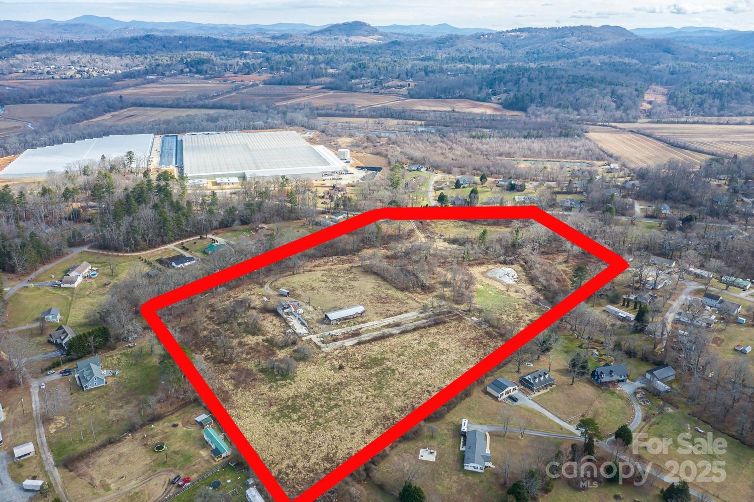 23.38 acres situated between Mills River and Horse Shoe, 13 minutes to WNC Ag Center. 15 minutes to downtown Hendersonville. 15 minutes to Asheville airport. 30 minutes to downtown Asheville. 40 minutes to TIEC. The possibilities are endless with this property as it is suitable for many different uses including: light industrial, commercial, residential development, agricultural, livestock, private equestrian estate. Much of the property is fenced and there is a large older barn on site as well as several outbuildings. A small stream runs along the left edge of the property. Power is in place and there is well on site. Connection to Henderson County municipal water system is possible according to Hend Co Operations Dept. There is an old farmhouse from the 1930's on site that holds little value, it could either be removed or renovated.