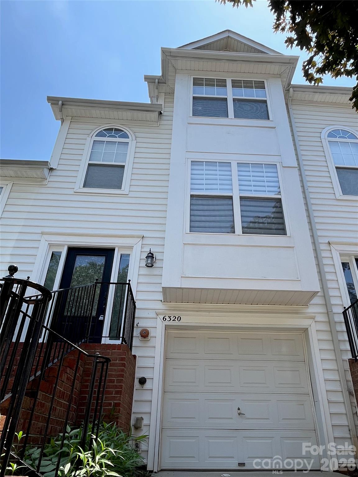 Welcome to this beautifully refreshed townhome in the gated Avalon at Mallard Park community, complete with a sparkling pool. Enjoy the ease of low-maintenance living—HOA covers lawn care, exterior upkeep, and the pool, so you can relax. Step inside to fresh paint, modern light fixtures, and newer flooring—everything is move-in ready. The versatile lower-level room is perfect for a home office or a third bedroom. You’ll love the convenience of an attached one-car garage plus a private deck off the living area. The open floor plan brings in plenty of natural light, and the spacious primary suite boasts a walk-in closet and en suite bath with a double vanity. Centrally located near UNCC, Northlake Mall, and major highways like I-77, I-85, and I-485, plus the seller is including a one-year home warranty. Don’t miss out—schedule your tour today!  Some Photos are virtually staged.