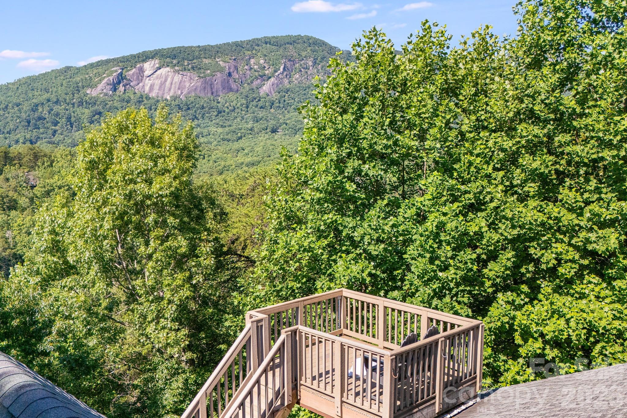 Turn-Key Mountain Retreat with Panoramic Views & Proven Rental Income!  With views of Bald Mountain in the sought-after Rumbling Bald Resort, this fully furnished escape offers breathtaking long-range views and exceptional amenities, including private lake access, two golf courses, pools, fitness center, hiking trails, and more. A successful short-term rental, the home features 2 bedrooms on the main level plus a lower level with a 3rd bedroom, additional sleeping room (3BR septic permit), and an entertainer’s dream game room with pool table, air hockey, ping pong, and putting green.  Recent upgrades include beautifully refinished oak hardwood floors, new bathroom tile, all-new lower-level and upstairs bedrooms carpet, new dishwasher and TV, drywall ceilings, new deck boards, stylish outdoor furnishings, living room furniture, new water heater and fresh bed linens. Whether you’re seeking a private mountain getaway or an income-producing investment, this move-in-ready retreat delivers unmatched value and year-round appeal.
