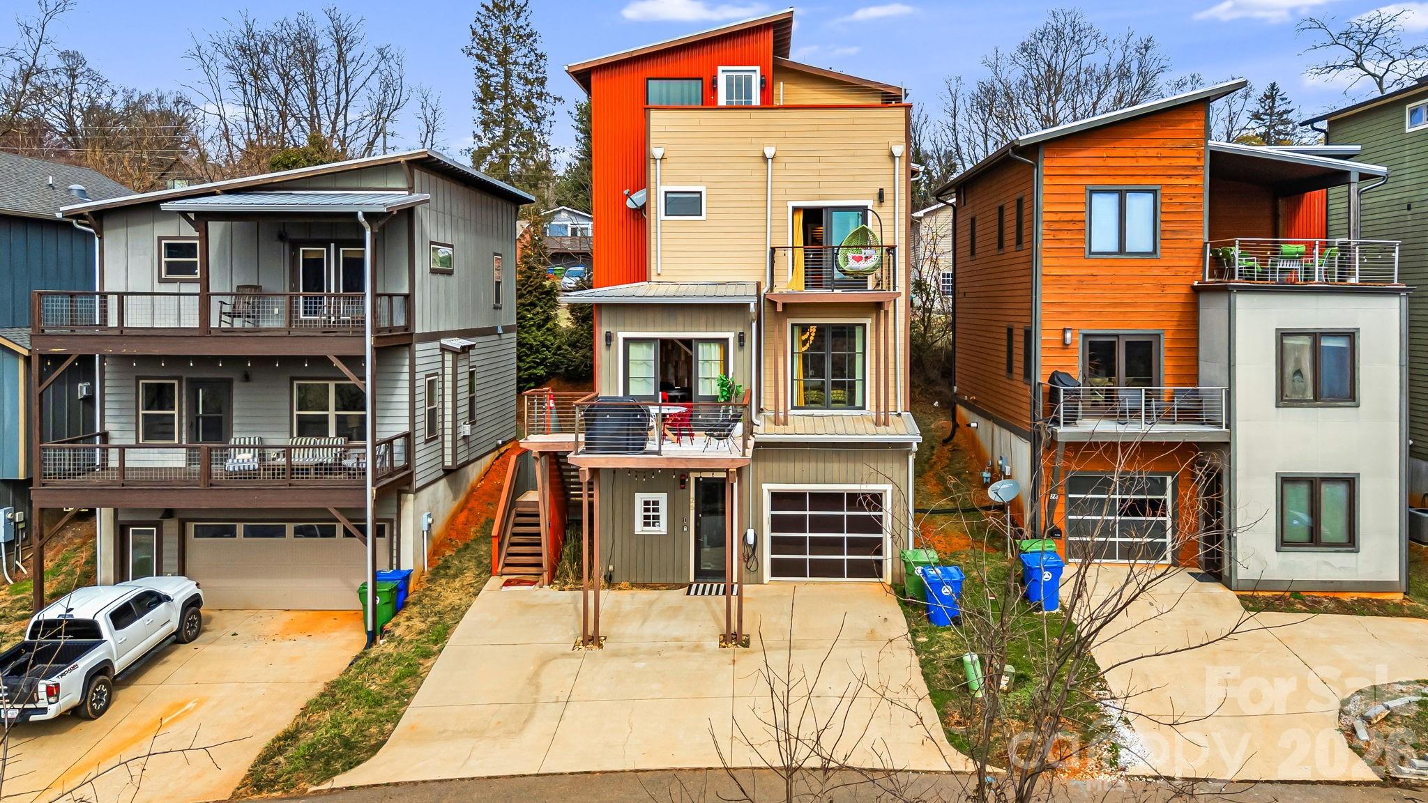 The Luxury Asheville Affair is a bold, experience-driven property positioned just minutes from Downtown Asheville, West Asheville’s culinary corridor, the Biltmore Estate, and the Blue Ridge Parkway. Overlooking the French Broad River and near Carrier Park’s greenway system, this multi-level residence blends vibrant design with large-scale functionality. The home features expansive open living areas, a fully equipped chef’s kitchen, and multiple themed entertainment spaces including a neon-lit lounge with DJ station, karaoke setup, poker table, and arcade gaming area. A rooftop terrace with private hot tub captures sweeping mountain and river views, while additional decks and balconies provide seamless indoor-outdoor flow. Designed for high-occupancy stays, the flexible bedroom configurations and amenity-rich layout position the property as a standout short-term rental opportunity. With its rare combination of location, capacity, rooftop views, and curated entertainment spaces, this property offers exceptional income potential in one of Asheville’s most sought-after markets.