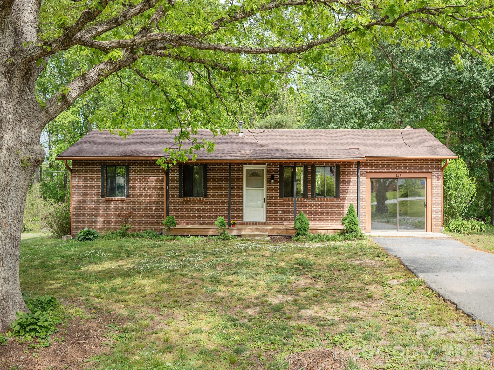 Sweet brick ranch on a large level lot with mature trees in a very convenient location. Comfortable neighborhood setting with generous lots, just minutes from charming Hendersonville and Flat Rock. This classic ranch style all one level home makes an ideal first home, retirement home or investment property and boasts hardwood floors and a stainless steel fridge. The finished former garage makes a versatile bonus room, the perfect spot for a home workspace or recreation area with direct access to your own private haven on the back deck for grilling and hanging out while enjoying your expansive back yard. This ideal starter home is waiting for you!