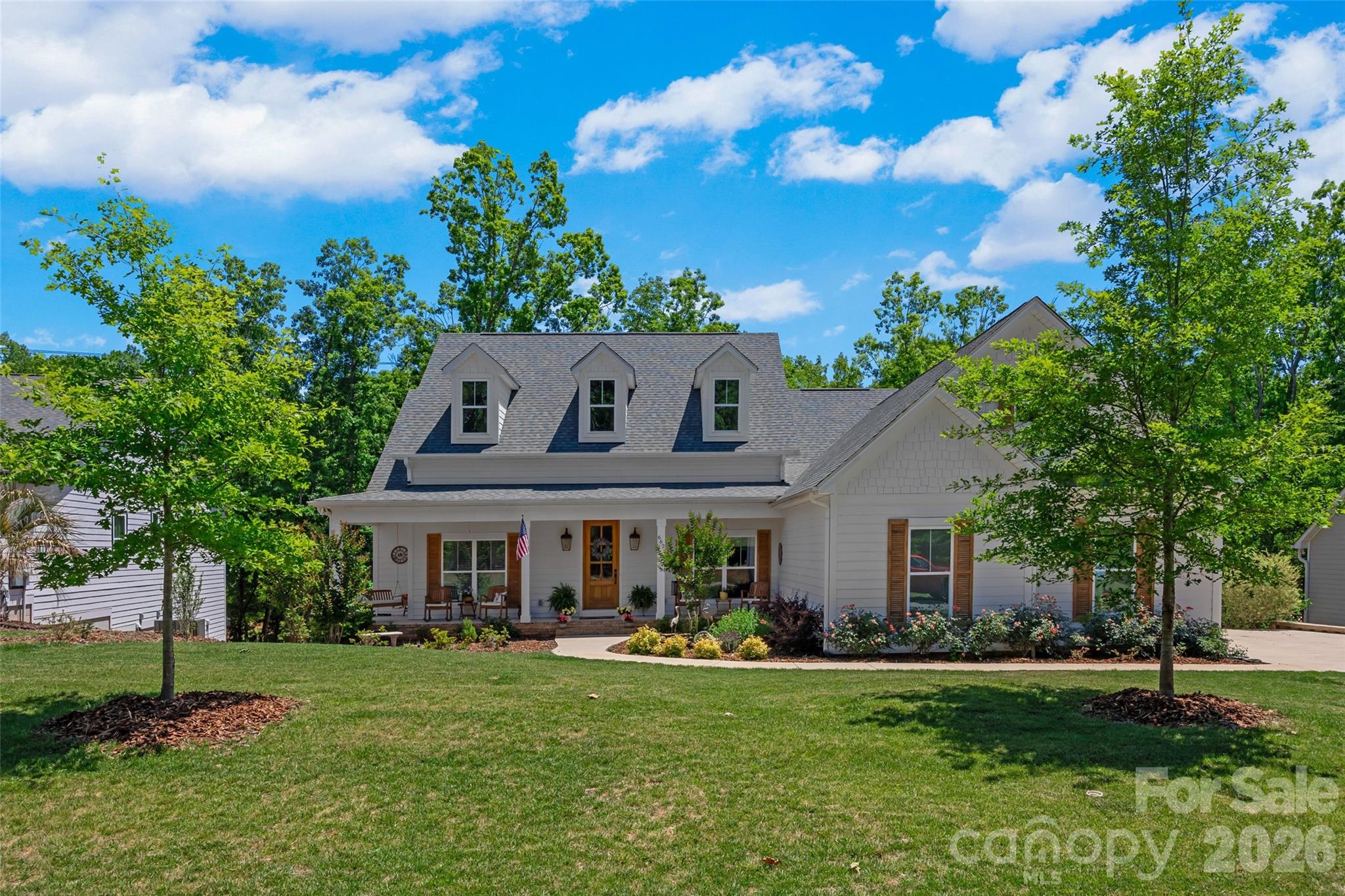 WOW! Waterfront custom build in the heart of Lake Wylie close to the bridge!  A stones throw to the main channel with none of the boat waves.  Almost new, gently lived in, meticulously maintained and built by custom builder for themselves.  The outdoor living areas and porches and multiple decks and views of the lake seal the deal on this home.  Gourmet kitchen with Brazilian Quartzite features upgraded appliances, double convection ovens, pot filler, custom cabinets for spices, pots, and cookware. Huge walk in pantry has built in microwave and china storage cabinet. Flooring throughout is engineered hardwoods. 2 sets of antique double doors in the home, antique corbels adorn great room as well as hand hewn beam on fireplace.  Primary bedroom with trey ceiling and spa-like bath with his & her closets and vanities. Large lighted jetted tub as well as shower with dual shower heads make this a place to relax from the day. 3 more bedrooms to accommodate the family or guests.   Office/flex space  is located in home for maximum privacy. Oversized 2 car garage with 8 foot clearance. Covered deck, sunning deck, and hot tub deck overlook the quiet cove. Hot tub to remain and new. Lots of storage for water toys under covered deck and crawlspace. Crawlspace is walk in and 10 feet tall in spots.  Home is located in the award winning Clover School District. Easy commute to Charlotte, Rock Hill and Gastonia or Belmont.  Charlotte International airport is only 30 minutes away.  You can drive your golf cart to the pool and amenities and to CVS.  Welcome home to the LAKE!!