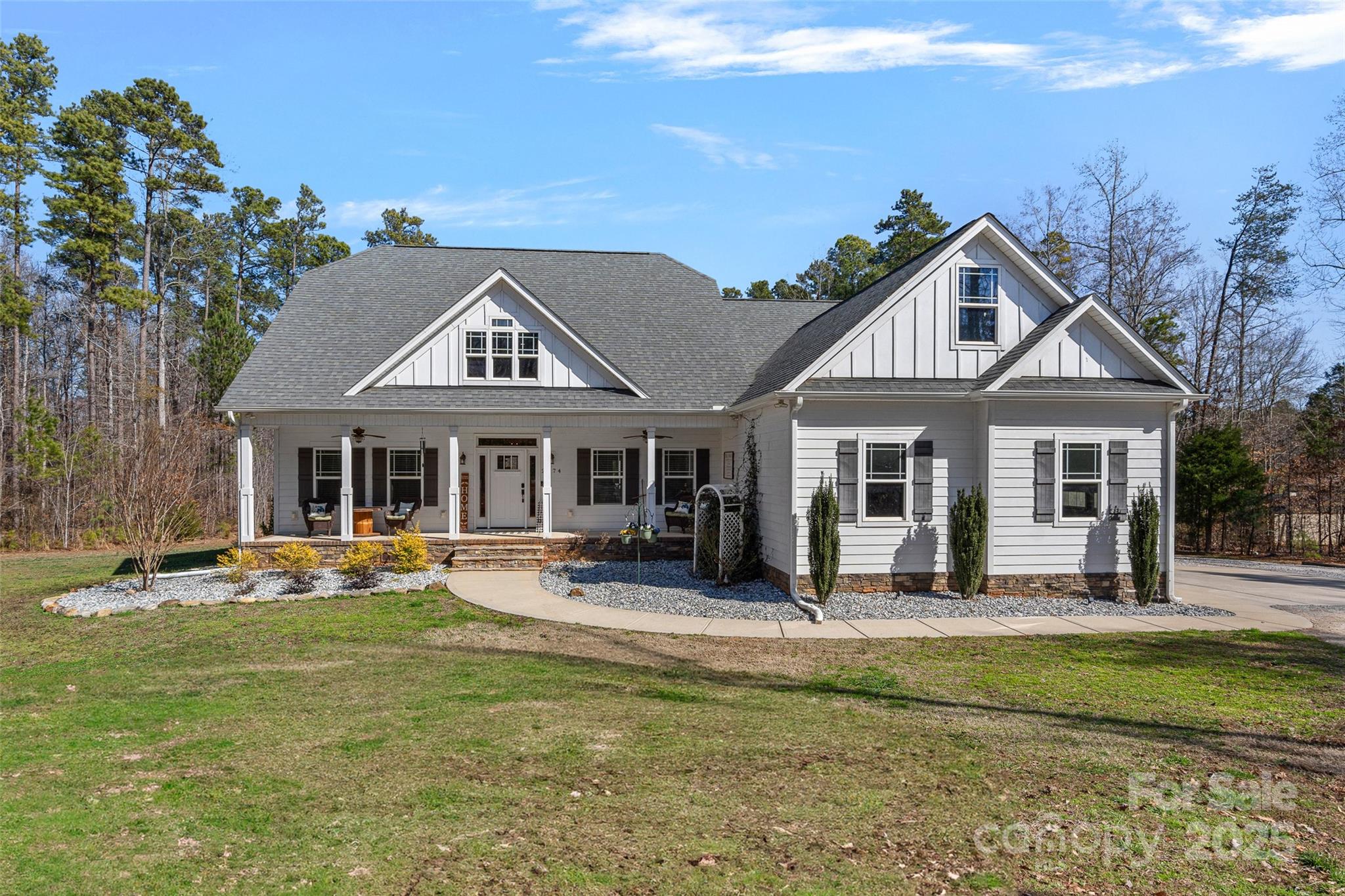 Your private retreat awaits at this stunning modern farmhouse nestled on 5 acres with No HOA! The covered front porch exudes southern charm and welcomes you through the front door where you'll notice the gleaming hardwoods, high ceilings & an abundance of natural light. This ideal open floor plan boasts a spacious living room with a gas fireplace that flow seamlessly to the dining room and gourmet chef's kitchen complete with a large island, granite countertops, gas range with pot filler & stylish tiled backsplash as well as a sunny breakfast area. Primary suite on the main level features a spa style bath & custom walk-in closet. 2 additional guest rooms and a full bath with dual vanity also on the main level as well as a planning center. Upstairs you'll find a sizable bonus room, modernized bath and 2 flex rooms. Relax by the fire on your screened in porch while over looking your private tree lined backyard complete with a salt water pool creating the perfect space for entertaining.