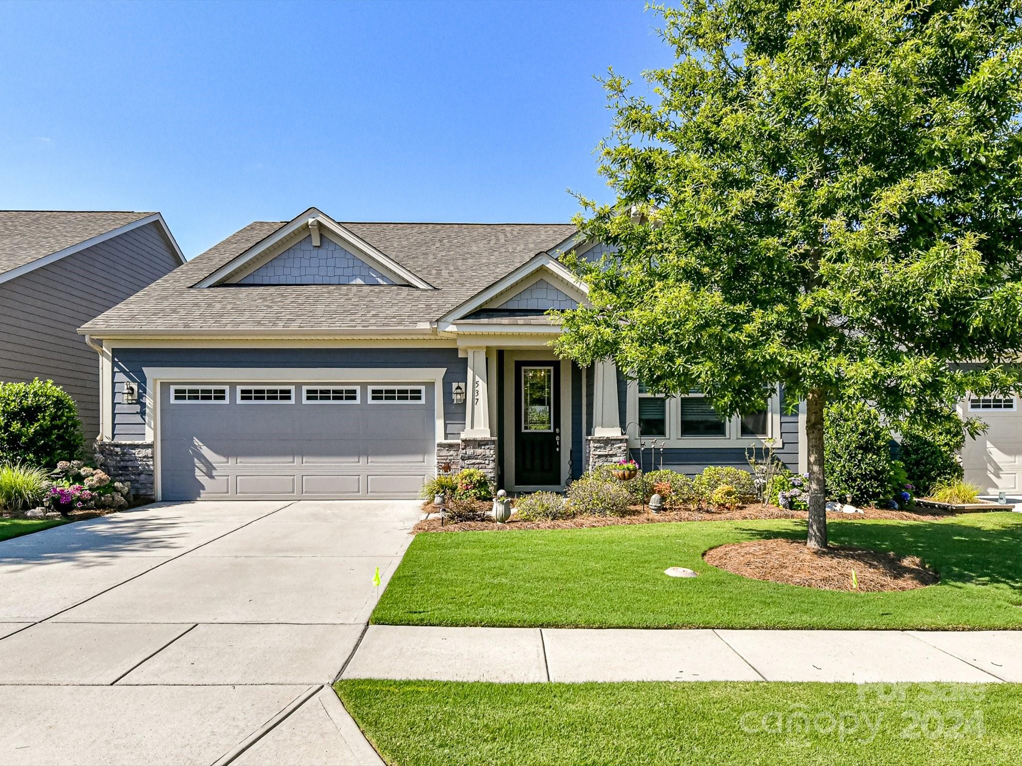 Absolutely stunning home in sought after Cadence in Tega Cay! You'll be impressed with this well-maintained home! A home office flanks the foyer as you enter the home. The elegantly appointed kitchen offers custom cabinets, wood hood, beautiful granite, large subway tiles, farmhouse sink, gas cooktop and a huge walk-in pantry.  The family room, dining and kitchen are all situated in an open floorplan, and all tied together with LVP flooring. The primary is located on the main floor with an amazing walk-in shower and a large closet that has direct access to the laundry room. The home also features two more additional bedrooms, one also located on the main floor and one upstairs with a massive bonus room. Wait until you see the back yard with an impressive, covered patio and retractable awning. This is one you really should hurry to see, it's gorgeous!