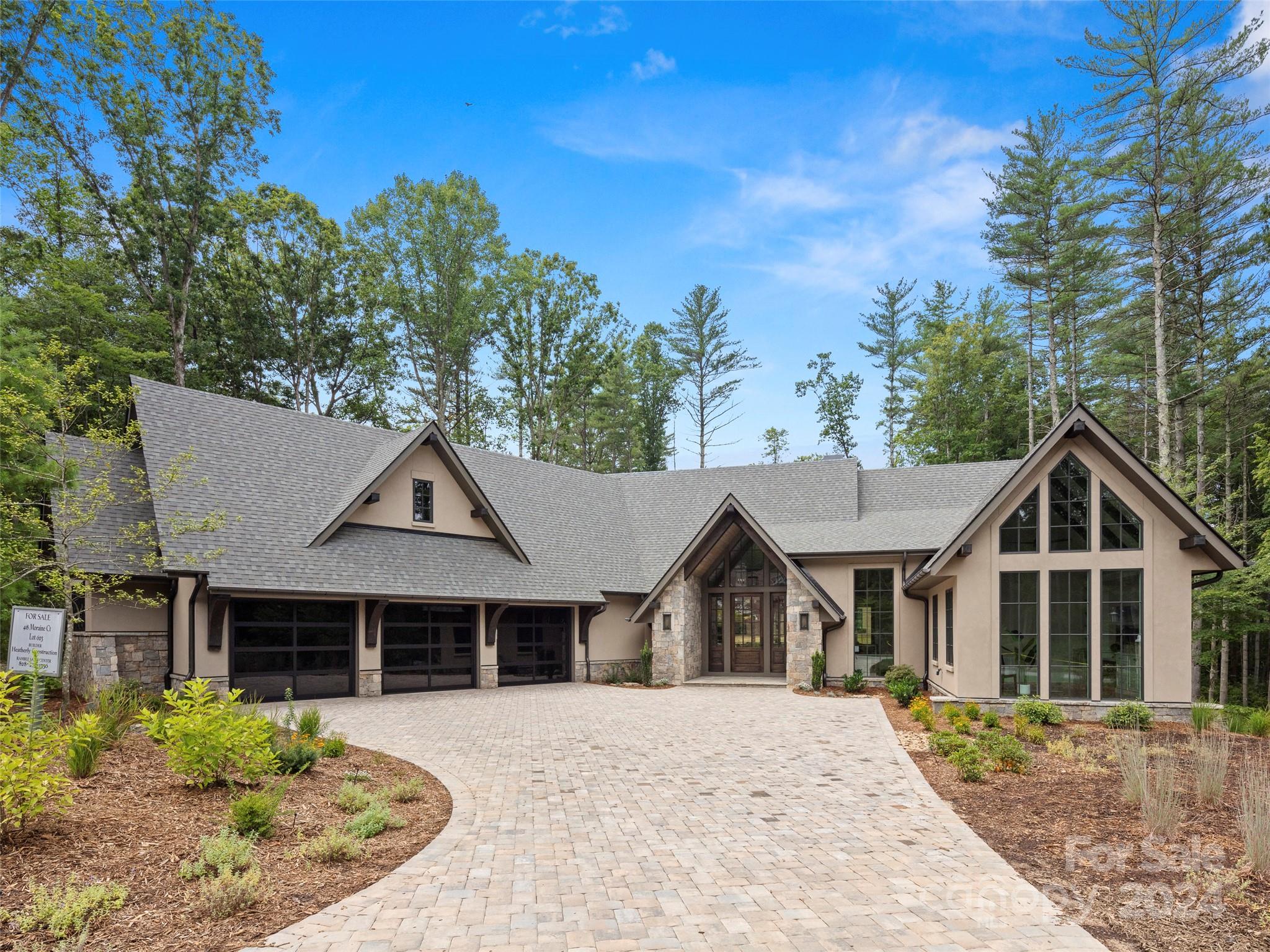 Nestled in The Ramble, one of Asheville’s premier luxury communities, this contemporary new construction home is as stunning as it is special. As you place your hand on the grand entry door, you immediately feel the quality that is synonymous with a Heatherly Construction built home. Stepping inside, your eyes are drawn to the expanse and beauty of this open concept floor plan. Abundant light fills the two-story great room through the large windows and sliding doors that open onto your beautiful and private covered porch that practically doubles your entertainment space. From the fantastic chef’s kitchen to the exceptionally well-appointed primary bedroom en suite, you are enveloped by high-end finishes. This home boasts three additional en suites, a bar and game room, and study. Near walking trails and the Living Well Center you are close to everything, yet you feel like you are tucked far away in your own secluded oasis!