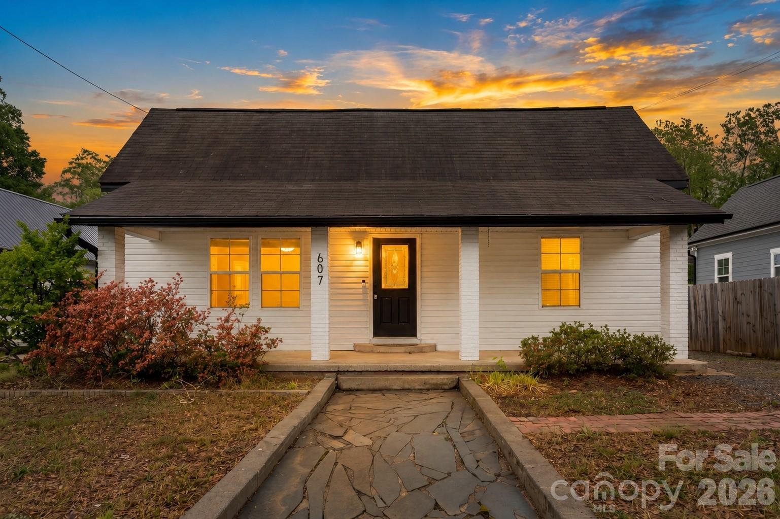 Vintage charm meets modern convenience in this stylishly updated home in booming Concord. Relax on the rocking chair front porch, or the back deck overlooking the fenced yard. Inside, the living areas are spacious and offer flexibility. A front living room opens to den/dining space and then to the kitchen. It has white cabinetry, granite countertops, stainless appliances and a roomy island. There are 3 bedrooms and 2 renovated baths, including the primary suite with walk-in closet and private bath. LVP flooring throughout, with no carpet. This home is turnkey, with all appliances remaining, including washer/dryer, and a new water heater. Central location with multiple ways to get to I-85, and just a five minute drive to downtown Concord. Welcome home!