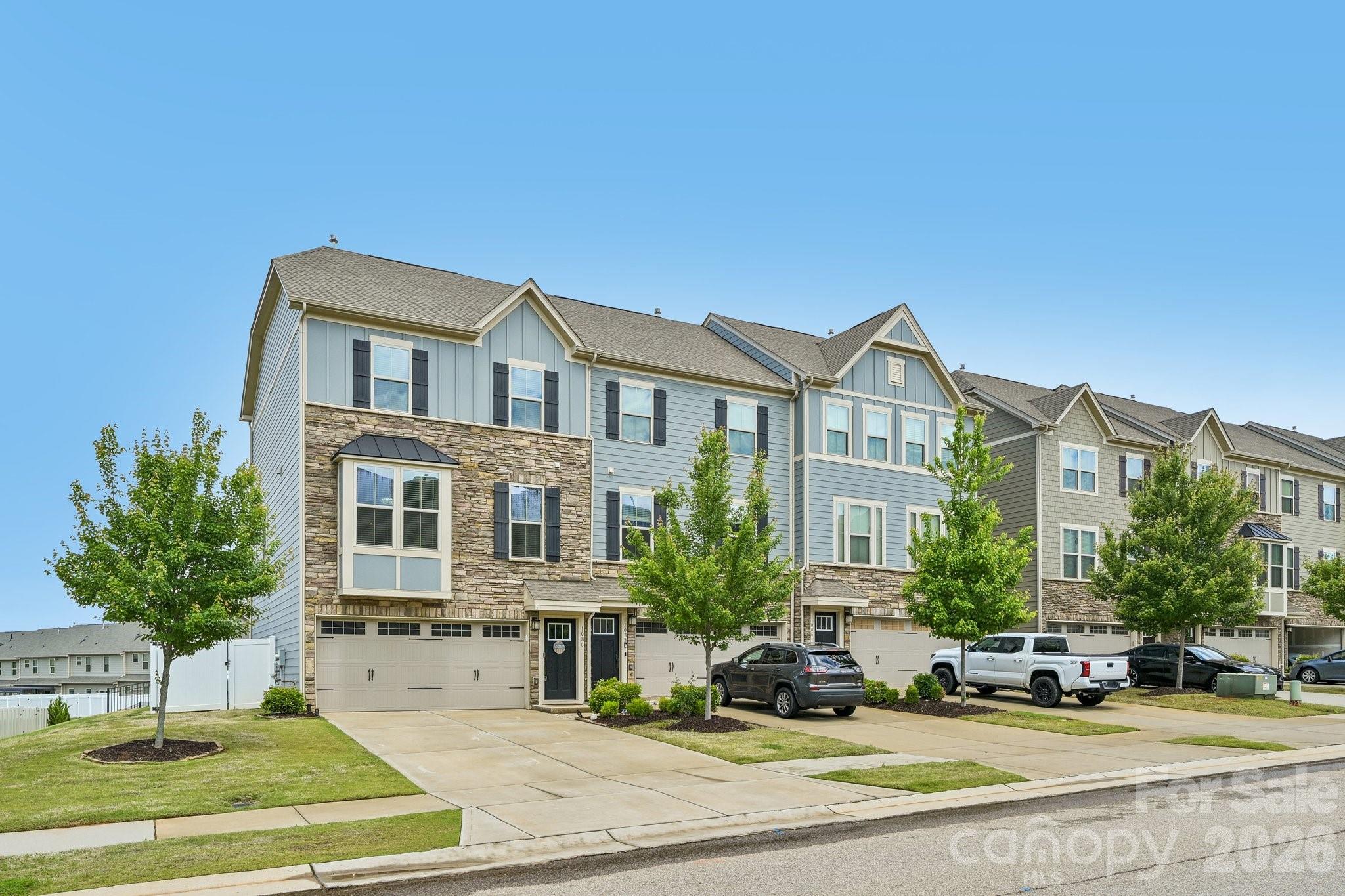 End-unit townhome with one of the larger yards in the community and upgrades that truly set it apart. The open floor plan flows seamlessly from the living room to the kitchen and dining area, where a custom wood accent wall adds warmth and character before opening onto the large elevated pergola-covered deck overlooking the fenced backyard—an ideal space for entertaining or relaxing outdoors.

The lower-level outdoor retreat features a stamped concrete and paver patio, artificial grass, outdoor fan, and even a sauna—offering a rare amount of usable outdoor living space for townhome living.

Inside, this 3-story home combines low-maintenance living with luxury finishes including 9’ ceilings, quartz countertops, modern cabinetry, built-in closet systems, and a spacious 2-car garage. Kitchen upgrades include a drinking water filtration system plus a whole-house water filtration system.

Located in highly desirable Waterfront at Langtree, this community is known for its luxury lake lifestyle and maintenance-free living. Residents enjoy waterfront recreation areas, paddle-sport launch access, scenic sunset gathering spaces with pergola and fire pit, and easy access to nearby marinas and Lake Norman recreation. Just off I-77 Exit 31 and directly across from Langtree Village, you can walk to restaurants, shopping, and entertainment while remaining conveniently located between Davidson and Mooresville.

A rare opportunity to own a highly upgraded end unit with exceptional indoor-outdoor living space in one of the Lake Norman area’s most convenient and lifestyle-focused communities.

Refrigerator, Washer, Dryer, Pergola, Sauna, Filtration System all convey.