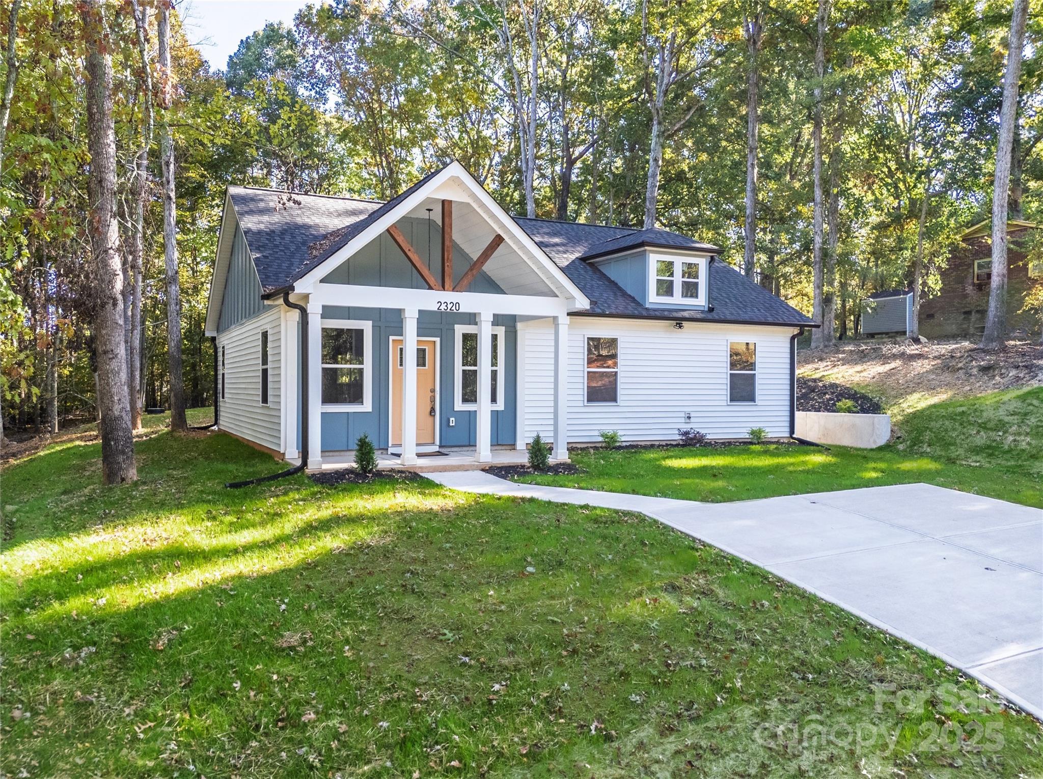This breathtaking new construction home is nestled on a large secluded lot surrounded by mature trees, offering  exceptional privacy in a peaceful natural setting. You'll be greeted by the vaulted front porch welcoming you in the home with extended height cathedral ceilings and open floorplan with lots of windows inviting natural light and scenic views of the surrounding landscape. LVP floors seamlessly lead you into the gorgeous kitchen with peninsula and bar seating, granite ctrs, soft close cabinetry, farmhouse sink, tile backsplash and hood vent, while the dining area invites you through the sliding glass doors to the private patio. At the end of the day, relax in the amazing primary suite with tray ceiling, accent wall and LVP floors. No detail has been overlooked in the unbelievable primary bath showcasing an oversized tile & glass surround shower with rainfall, tile floors and dual vanity w/ granite counters. There are 2 add'l bedrooms, ample in size, plus hall bath w/ tile surround shower, granite counter & tile floors. Additional highlights include a .47 acre lots that feels triple the size, dedicated laundry room, no carpet - all tile & LVP floors, connected to public water, no HOA, plus so many upgrades and custom features for this amazing price! You'll appreciate the quality construction and elevated finishes - not an average cookie cutter home! 10-year Structural warranty included, pay ONLY County taxes and close to everything you need - 1.5 miles from John Moss Lake, 2.5 miles from E Dixon Blvd, 5 miles from downtown Shelby, 14 miles to Gardner Webb University. *USDA ELIGIBLE with no down payment. You may also qualify for up to $20,000 in down payment & closing cost assistance! Call preferred lender for details!