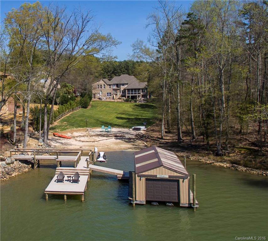 Privately gated waterfront Estate with separate huge 1300+ guest house included in sq footage and oversized second garage. Resort style backyard with saltwater pool and hot tub, waterfall and outdoor fireplace. Screened porch and lower covered porch, new boat lift and remote garage door on boat house as well as trex dock. Sandy beach and floating dock. Security system with camera. 2015 taxes were $2,739 Clover schools, no HOA fees. Total sq ft. 6000+