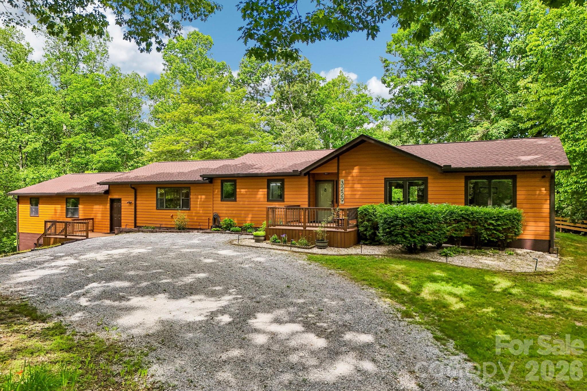 Beautifully updated 3-bedroom, 2-bath home offering 2,285 square feet of thoughtfully designed living space. This move-in-ready property features new engineered hardwood flooring throughout and a completely renovated kitchen with high-end countertops, new cabinetry, custom pantry storage, and new appliances. The spacious primary suite has been transformed into a private retreat with a custom-tiled shower and vanity. Enjoy outdoor living year-round on the large screened porch with vaulted ceiling, new Trex decking and expansive patio area. Major updates provide peace of mind, including a new roof (2024), Pella windows, mini-split systems (2018), fully encapsulated crawlspace, updated plumbing, and new garage door openers. The oversized two-car garage offers exceptional storage, while the large flex space and unfinished area above the garage provide endless possibilities for a home office, gym, hobby room, or future expansion. Sitting on just shy of 2 acres, peaceful setting with cleared, level back yard with loaded blue-berry bushes and large shed for your gardening tools and mower.