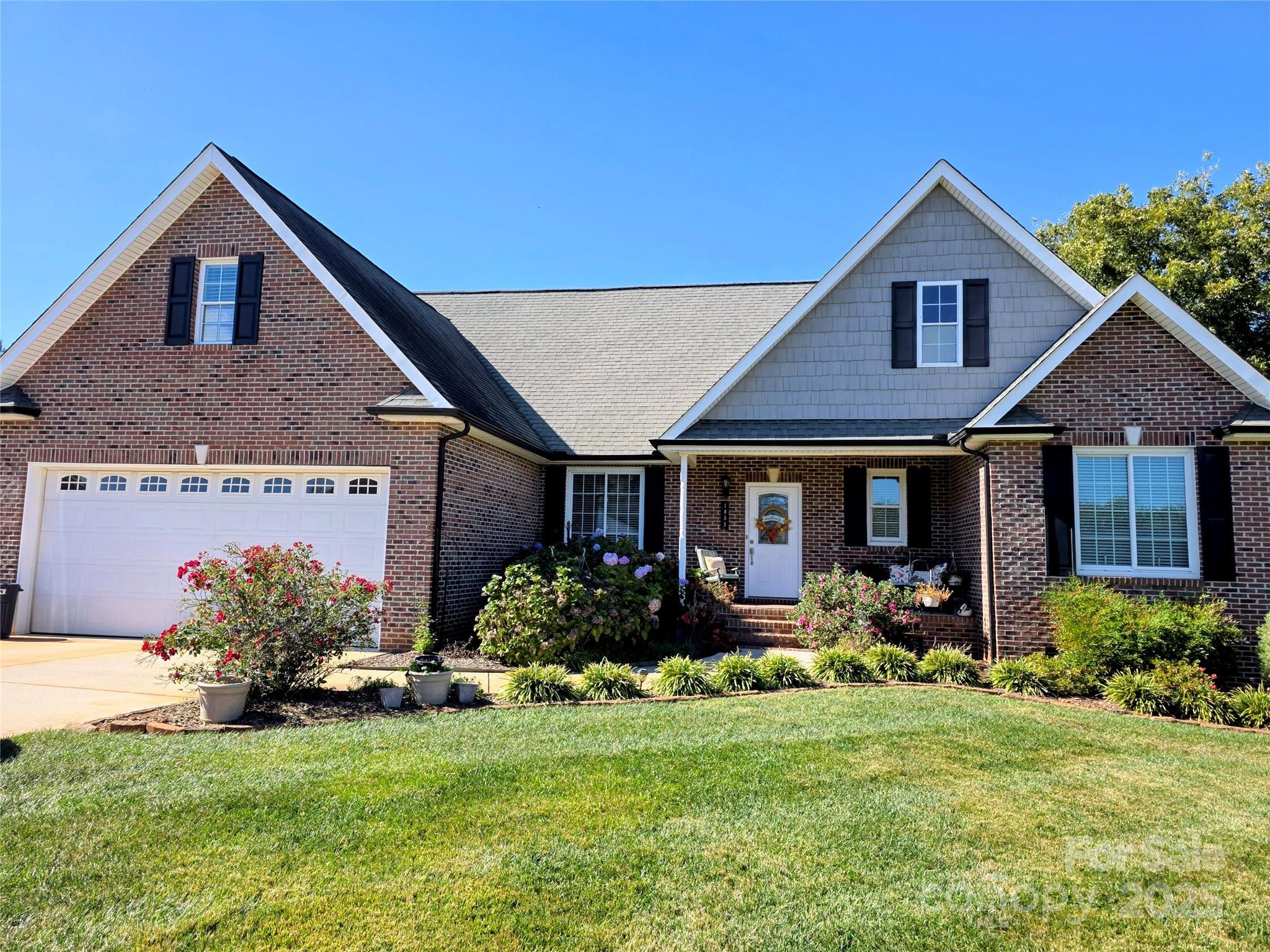 This beautifully maintained custom-built home sits on a level, half-acre lot and offers exceptional curb appeal. Inside, you'll find hardwood flooring throughout the main living areas and primary bedroom, along with a spacious, open floor plan and soaring ceilings that create an inviting, airy feel. The modern kitchen features updated appliances and convenient access to the covered deck—also accessible from the living room—making it perfect for entertaining or relaxing outdoors. Additional highlights include Andersen windows and a Trane HVAC system, HVAC installed approximately two years ago for peace of mind and energy efficiency.  Double garage with expoxy coating on the floor. Yard is level and well-manicured.

A finished room above the garage provides valuable flex space ideal for a home office, playroom, or guest area. Move-in ready and thoughtfully designed, this home offers comfort, style, and the benefits of county living where you pay no City taxes.