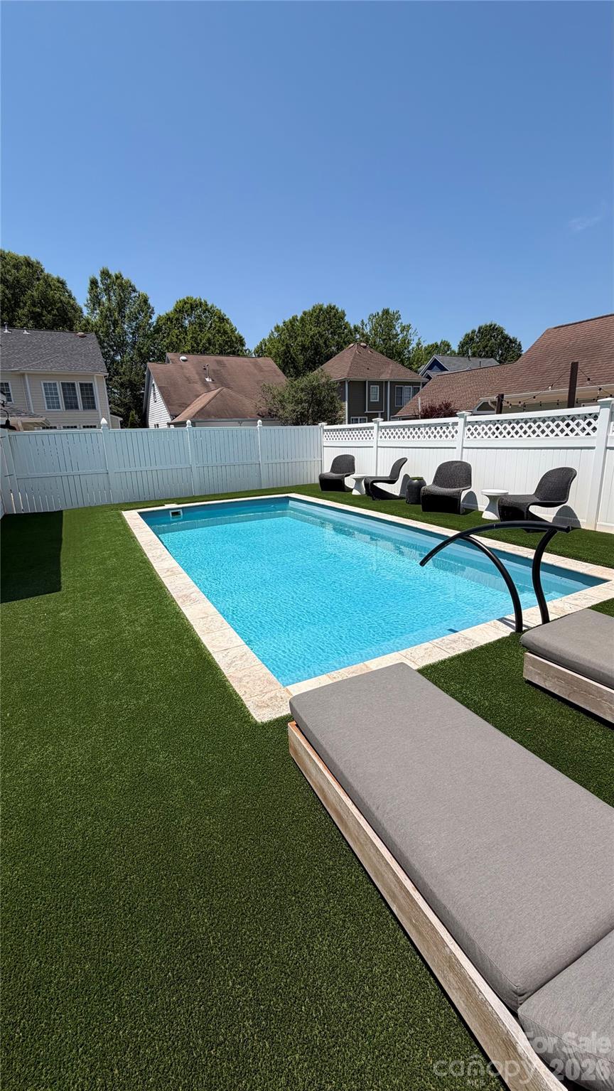 Enjoy the backyard playground of this great home!

A true back-yard retreat featuring a heated saltwater pool, hot tub, 4 hole putting green and floating pet turf with concrete underneath for zero maintenance enjoyment.  Perfect for relaxing, entertaining, or unwinding with family and friends. 
The Southern Charm of the TWO front porches is great year-round, especially with the front view of the park across the street. Serene and Relaxing view
Inside you have convenience with Savant Smart Home automation that can control TV's, music and lighting throughout.  

The main level welcomes you with a wonderful formal dining room and sitting room complete with a Butler's Pantry & beverage refrigerator. The spacious family room boasts a Fireplace with gas logs and opens up to the rear deck and backyard creating effortless indoor/outdoor flow.
Adjacent is the eat in kitchen with breakfast bar, ideal for casual meals and gatherings.  

Upstairs, the Primary Bedroom is a true Retreat with custom lighting in the tray ceiling and a beautifully updated spa class bathroom featuring a beautifully updated spa class shower. Two additional bedrooms share a Jack and Jill bathroom, and each has private access to the upper porch.  

BAXTER VILLAGE LIFESTYLE at its finest: Walking trails, The Community Center, Community Pool, Tennis Courts, Parks and the Vibrant Town Center with shops and restaurants are steps away alongside top-rated Fort Mills Schools.  

This gem delivers luxury, low maintenance and the ultimate in outdoor living.
Don't miss your opportunity to own a piece of Baxter Village paradise!
