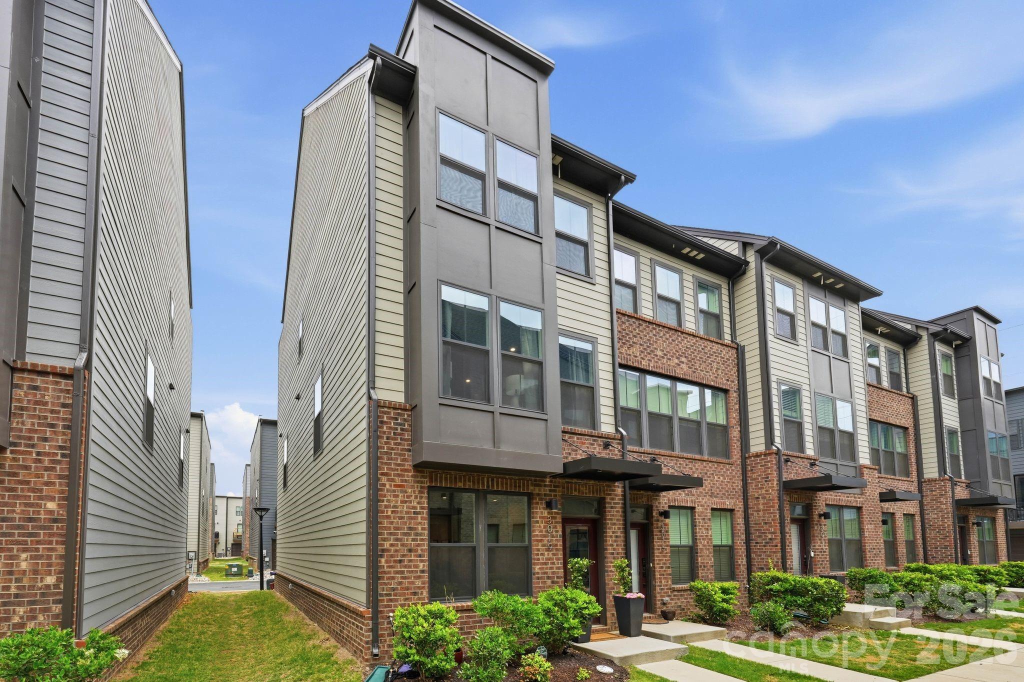 Welcome to 3019 Terroir Lane, a prime end-unit townhome in the LoSo neighborhood, offering stunning rooftop city skyline views and unbeatable convenience. Ideally located within walking distance to LoSo’s popular bars, restaurants, breweries, and entertainment, with quick access to Charlotte Douglas International Airport, I-77, South End, Uptown, and SouthPark.
Completed in Fall 2023, this like-new townhome features 3 bedrooms, 3.5 bathrooms, and a versatile dedicated workspace on the entry level — perfect for a home office, studio, additional living area, or potential bedroom setup for those desiring  4 bedrooms. Thoughtfully upgraded throughout with luxury vinyl plank flooring (no carpet!), custom built-ins with premium countertops, upgraded tile and fixtures throughout,  this home combines modern style with functional living and convenience.
Whether you're entertaining on the rooftop terrace or enjoying the vibrant lifestyle LoSo has to offer, this is the townhome you've been waiting for. Don’t miss your opportunity to call 3019 Terroir Lane home!