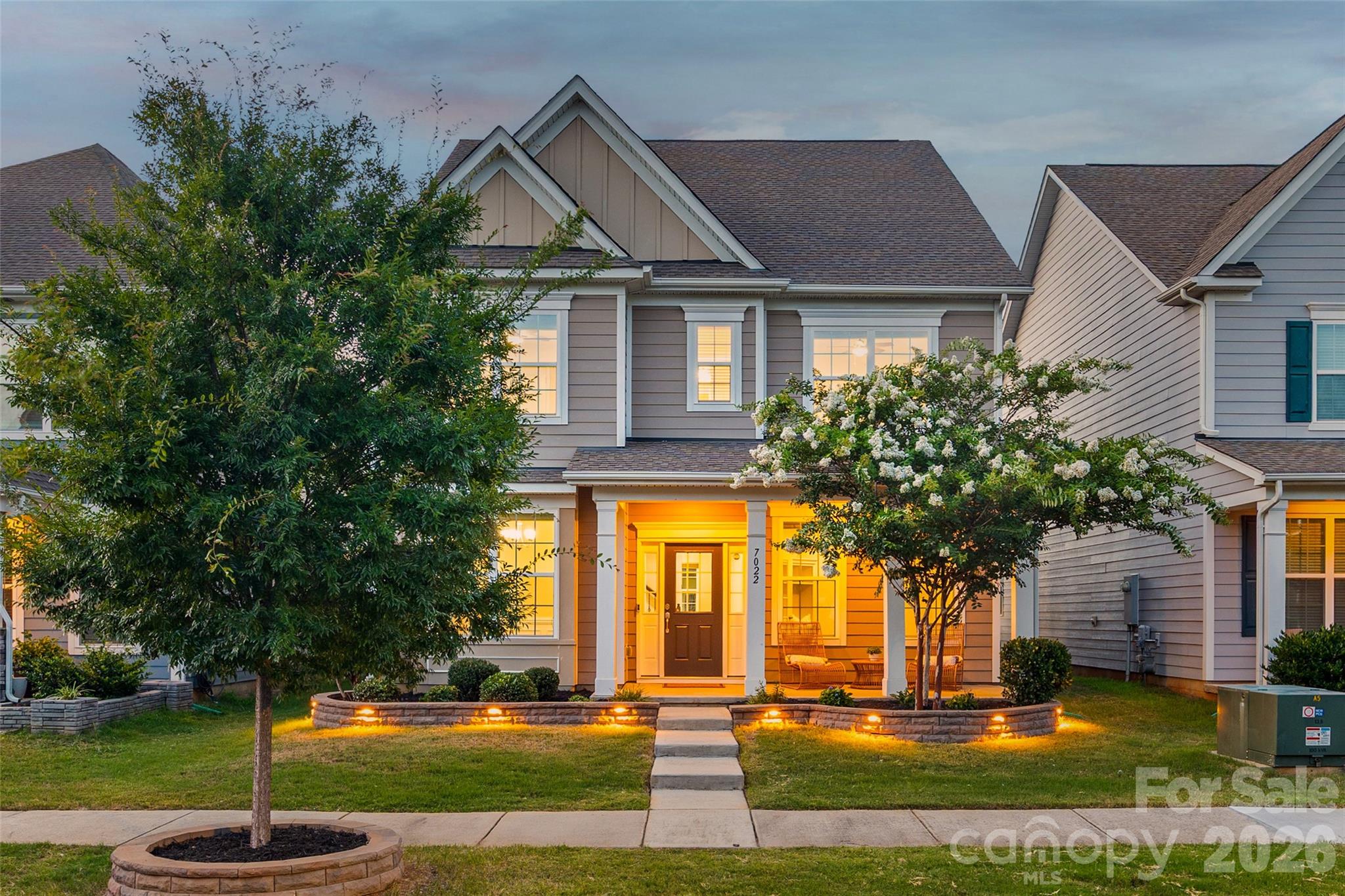 This meticulously-maintained Rea Farms home is the perfect blend of modern luxury and convenience! Located in the highly-desired Ardrey Kell High School district, this home will impress you from the minute you walk in. The covered front porch invites you to relax and leads you onto gorgeous wood floors that run throughout the main level. Flanked by a formal dining space with heavy moldings, and an office with french doors, the abundant natural light creates a welcoming presence. At the heart of the home is a gourmet kitchen, boasting an enormous island with tons of room for seating, double ovens, a gas cooktop, stainless steel appliances, an included refrigerator, walk-in pantry, gleaming tile backsplash, and more. A gas fireplace gives a cozy ambiance in the great room, with a view to the spacious backyard. As you head past the breakfast area, a covered patio is perfect for entertaining, and the fenced yard is level for enjoying. A detached garage has epoxy floors, storage shelves above, and a 240V (level 2) EV CHARGER for your vehicles! As you head upstairs, prepare to be wowed by the primary bedroom with a large sitting area. Picture evenings relaxing by your private gas fireplace in the primary suite, or use it as an additional office space - the possibilities are endless. The primary bathroom gives you a spa atmosphere with soaking tub, dual vanities, walk-in tiled shower, water closet, and walk-in closet with built-in storage. Rounding out the upstairs you'll find an ideal layout with a Jack-and-Jill bathroom for 2 bedrooms (featuring double sinks and separated spaces), and another secondary bedroom and a full bathroom. The home has too many details to mention, including 2 smart home access points, 2 Honeywell smart thermostats, fans in all bedrooms as well as the great room and back porch, washer/dryer and refrigerator, and more! Located only minutes from Waverly, Rea Farms, Whole Foods, restaurants, boutiques, and even a Target and HomeGoods, and with quick access to I-485, you won't want to miss the lifestyle this home has to offer.
