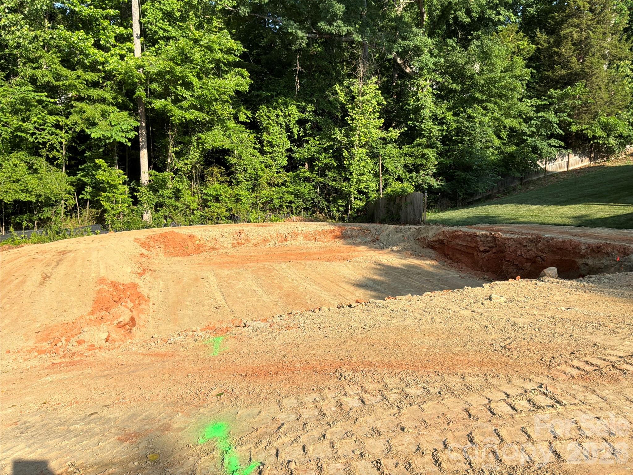 Shovel ready vacant lot located in an established subdivision steps away from the Toby Creek Greenway and minutes away from UNCC and Uptown. Full site plan approval by the City of Charlotte, allowing a buyer to move directly into construction without delay. The lot is already cleared, providing significant upfront cost and time savings, ideal for a smooth and efficient build. Public water and sewer tap fees have already been paid for, yielding a cost savings of $17,340. The neighborhood and surrounding area continues to see strong growth, with new construction homes on the same street selling for $425k+. Excellent opportunity for a builder, investor, or first-time ground-up project.