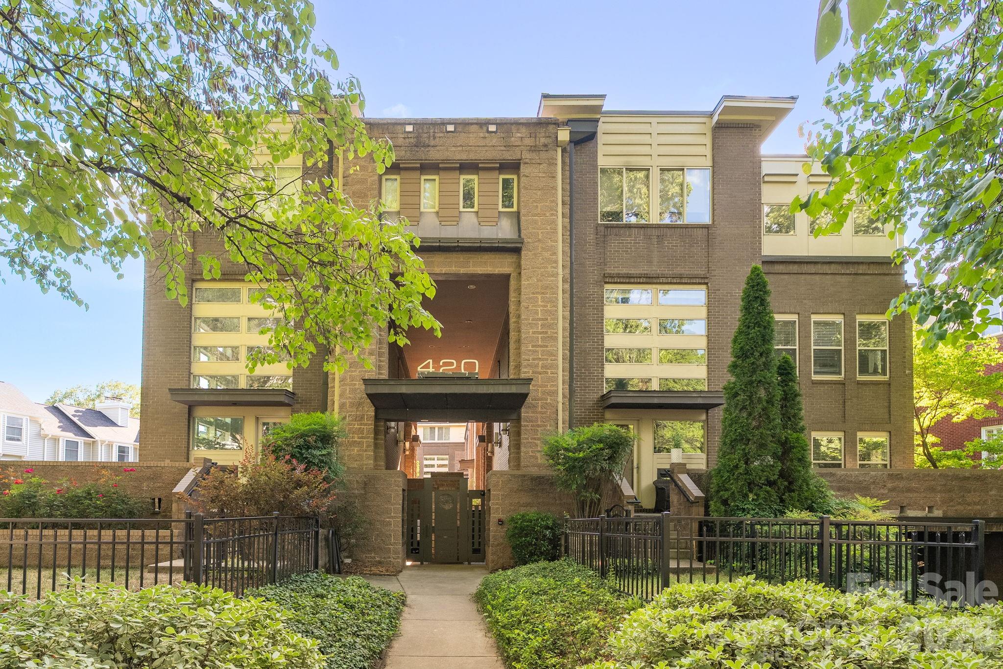 Experience modern luxury in the heart of Charlotte at 420 Queens Rd #10. This beautifully designed three-level residence offers the perfect blend of style, comfort, and convenience in one of the city's most sought-after locations. The open-concept floor plan is filled with natural light and features contemporary finishes, spacious living areas, and flexible spaces ideal for entertaining, working from home, or everyday living. The renovated gourmet kitchen is a standout feature, showcasing new cabinetry, quartz countertops, GE Café series appliances including a gas range with double oven, microwave, and dishwasher, and ample prep and storage space.
 The kitchen seamlessly flows into the dining area overlooking the living room, creating an inviting atmosphere for gatherings and daily life. The main-level living room is the heart of the home, featuring a stunning see-through fireplace that opens to the expansive wrap-around patio. This exceptional outdoor living space is complete with a built-in gas grill.  A desirable main-level guest bedroom with private patio access and a full bathroom featuring a walk-in shower provides the perfect space for visitors, multigenerational living, or a private home office. Retreat to the spacious primary suite featuring a beautifully renovated spa-inspired bathroom with a double vanity, walk-in shower, and relaxing soaking tub. Additional bedrooms and living spaces throughout the home offer privacy, comfort, and versatility across all three levels. Rare for urban living, this residence includes three dedicated parking spaces in a gated, secured parking garage along with two private storage units, providing exceptional convenience and ample storage. Enjoy the security and ease of lock-and-leave living in one of Charlotte's most desirable locations. Located along prestigious Queens Road, this exceptional home places you just minutes from Uptown Charlotte, Myers Park, top-rated dining, boutique shopping, parks, entertainment, and cultural attractions. Offering a low-maintenance lifestyle, luxury updates, outstanding outdoor living, and an unbeatable location, this distinctive property is a rare opportunity to own in the heart of Charlotte.