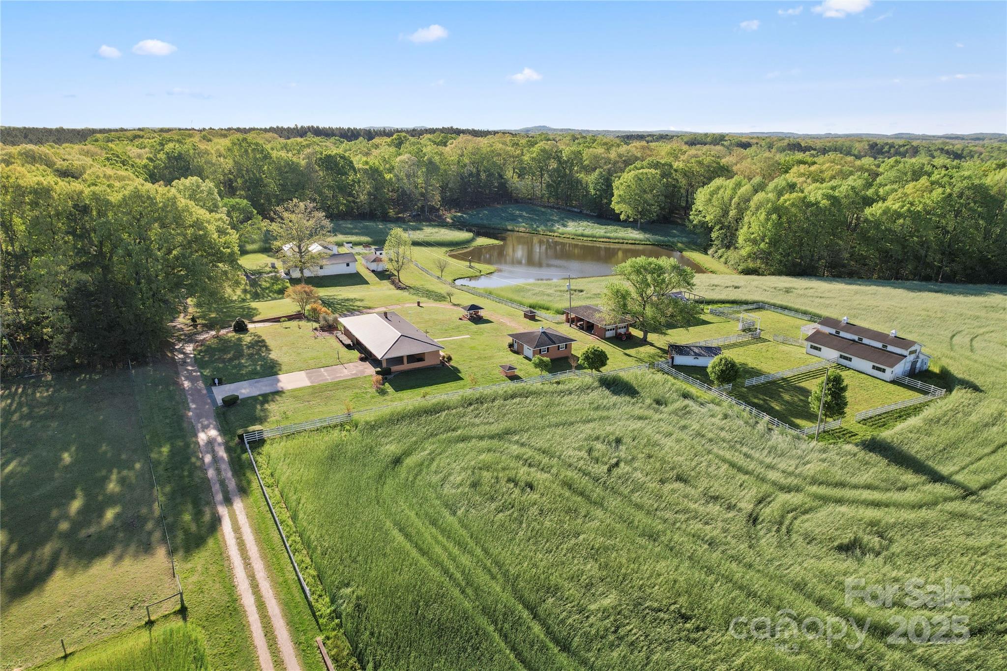 This unique property spans 29.98 acres across 5 parcels and offers a mix of residential and agricultural. Features include a 3 bedroom, 1 and a half bath main residence a barn with horse stalls, a separate building for miniature horses, an events venue, a church (needs a new roof and a lot of work inside), and a beautiful pond. A portion of the land is currently being farmed by a neighboring farmer, and the sellers request he be allowed to harvest his crops after closing. Ideal for equestrian use, events, or investment. Some of these uses will require a special use permit, due to the zoning. It's suggested buyers look into this prior to purchase for intended uses. Zoning Ordinance available upon request. Sold AS-IS with all furnishing and personal property on the property(excluding the tractor if it's still there) Air Conditioning replaced in Farmhouse July 2025. The building opposite the event center needs a new roof and is not safe to enter. There is an right of way easement coming into the property allowing the neighbor access to their home as well as access to this property. An unwritten agreement that splits costs to maintain into thirds with 2/3 paid by this property and 1/3 paid by the neighbor to avoid land lock.