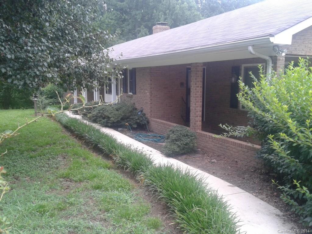 Private 3.17 acre beautifully landscaped lot has fruit trees, fig bushes and a great brick ranch home with spacious rooms, built in bookcases in Greatroom, lots of cabinets in kitchen,  fireplace, and huge sunroom plus 2 car garage and storage building. close to shopping, schools and I-485. No guarantee on gas logs in fireplace but you can burn wood. Must see this one.