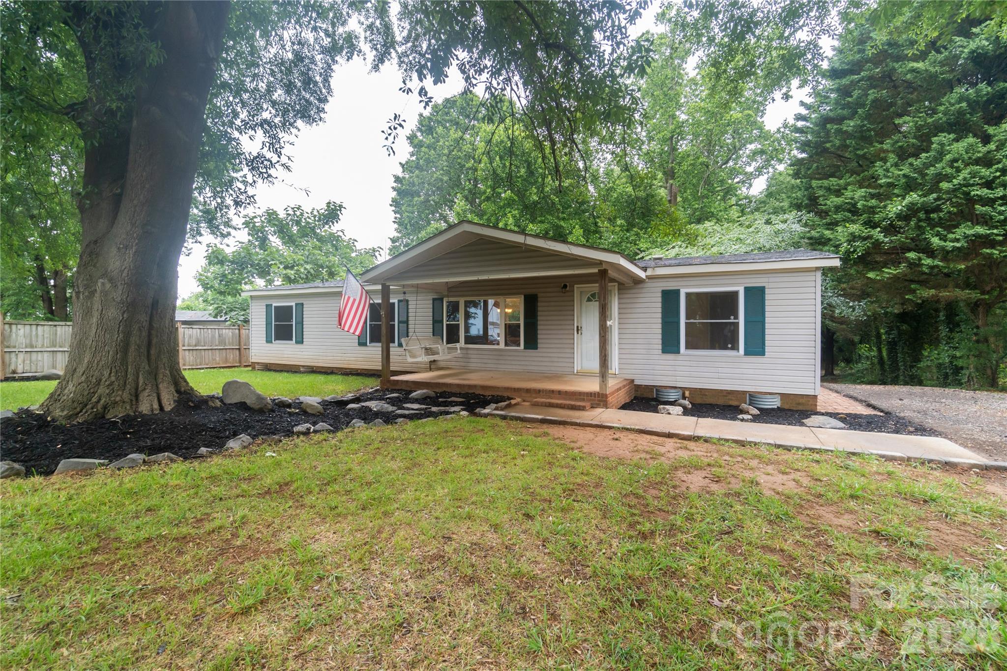 Updated and move-in ready home in established Charlotte neighborhood! This home features numerous recent upgrades, including a new roof (2022), new windows (2024), new laminate flooring, and updated bathrooms completed in 2024. The kitchen offers a gas stove and new dishwasher, while the home also includes gas heat and gas hot water heater (new in 2025). Cozy up by the beautifully updated fireplace, only used once since renovation. Enjoy outdoor living on the large back deck overlooking the backyard, plus a detached shed/workshop for extra storage or hobbies. Convenient location with easy access to shopping, dining, and major highways.