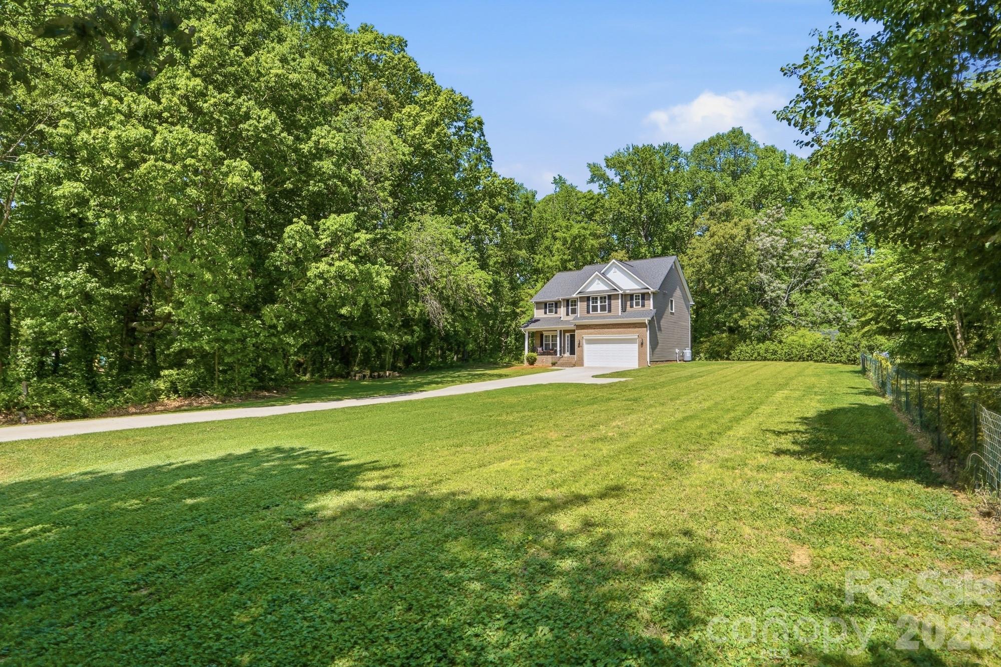 **NOW OFFERING A $4,500 LENDER CREDIT AT CLOSING FOR ANY BUYER THAT USES OUR PREFERRED LENDER! Looking for acreage and privacy?  This exceptional property delivers both.  This one-owner home, built in 2022, has been meticulously maintained and is situated on 1.92 acres, offering a peaceful wooded setting.  A long private concrete driveway leads to a spacious two car garage, providing both convenience & curb appeal.  Inside, you'll find an open and inviting floor plan featuring 3 bedrooms plus a versatile bonus room/optional fourth bedroom (on septic), along with 3.5 baths.  The beautifully appointed kitchen showcases granite countertops, a large island and a walk in pantry-perfect for both everyday living and entertaining.  The main level offers seamless open concept living with a cozy family room complete with a fireplace, as well as a separate dining room or study to suit your needs.  Durable luxury vinyl plank flooring runs throughout the main level.  The spacious primary suite boasts vaulted ceilings and an oversized walk-in closet. The en-suite bath includes a relaxing garden tub and a separate walk in shower.  Don't miss this opportunity- schedule your private showing today!