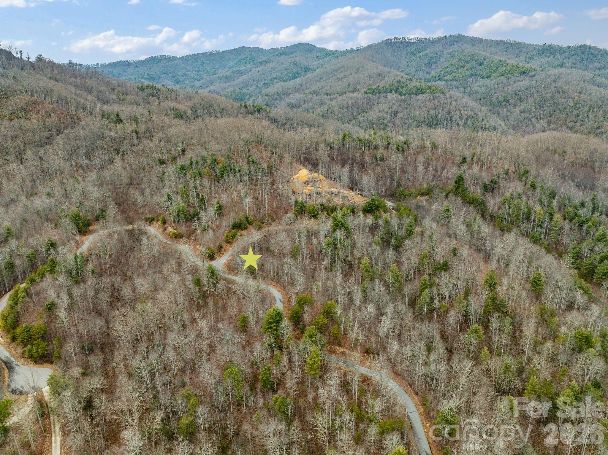 Escape to the Mountains: 3.2 Acres in gated Firefly Mountain
Experience the perfect blend of high-country seclusion and modern convenience. This sprawling 3.2-acre lot is tucked away within the gated community of Firefly Mountain, offering a rare opportunity to build your dream mountain retreat in one of Western North Carolina’s most scenic corridors.
The Best of Both Worlds - Located approximately 5 miles from the charming, historic town of Hot Springs, you’re minutes away from mineral baths, local breweries, and riverfront dining. When you need the "big city" amenities, you are perfectly positioned for a commute or a day trip: Weaverville: 30 minutes, Asheville: 40 minutes
A Paradise for Outdoor Enthusiasts the neighborhood is bordered by the vast Pisgah National Forest. Firefly Mountain serves as your private gateway to the wild.
The Appalachian Trail: Only a stone's throw away for world-class hiking.
River Adventures: Proximity to the French Broad River for kayaking, rafting, and fishing.
Nature at Your Door: Enjoy the peace and quiet of a neighborhood designed to coexist with the surrounding wilderness.
This generous parcel offers a sense of true privacy. The lot currently features serene winter mountain views, which can be expanded with selective tree clearing & the position of the homesite. Imagine your morning coffee on a wrap-around deck overlooking the rolling peaks of the Blue Ridge.
Whether you are looking to build a full-time residence or a vacation getaway, this property offers incredible flexibility. The HOA allows for short-term rentals, making this an ideal location for an income-producing luxury cabin in a high-demand tourism area.
Access: Paved roads and underground utilities available, along with high speed internet
Don't miss the chance to own a piece of the Appalachian dream where the forest is your neighbor and the mountains are your backyard.