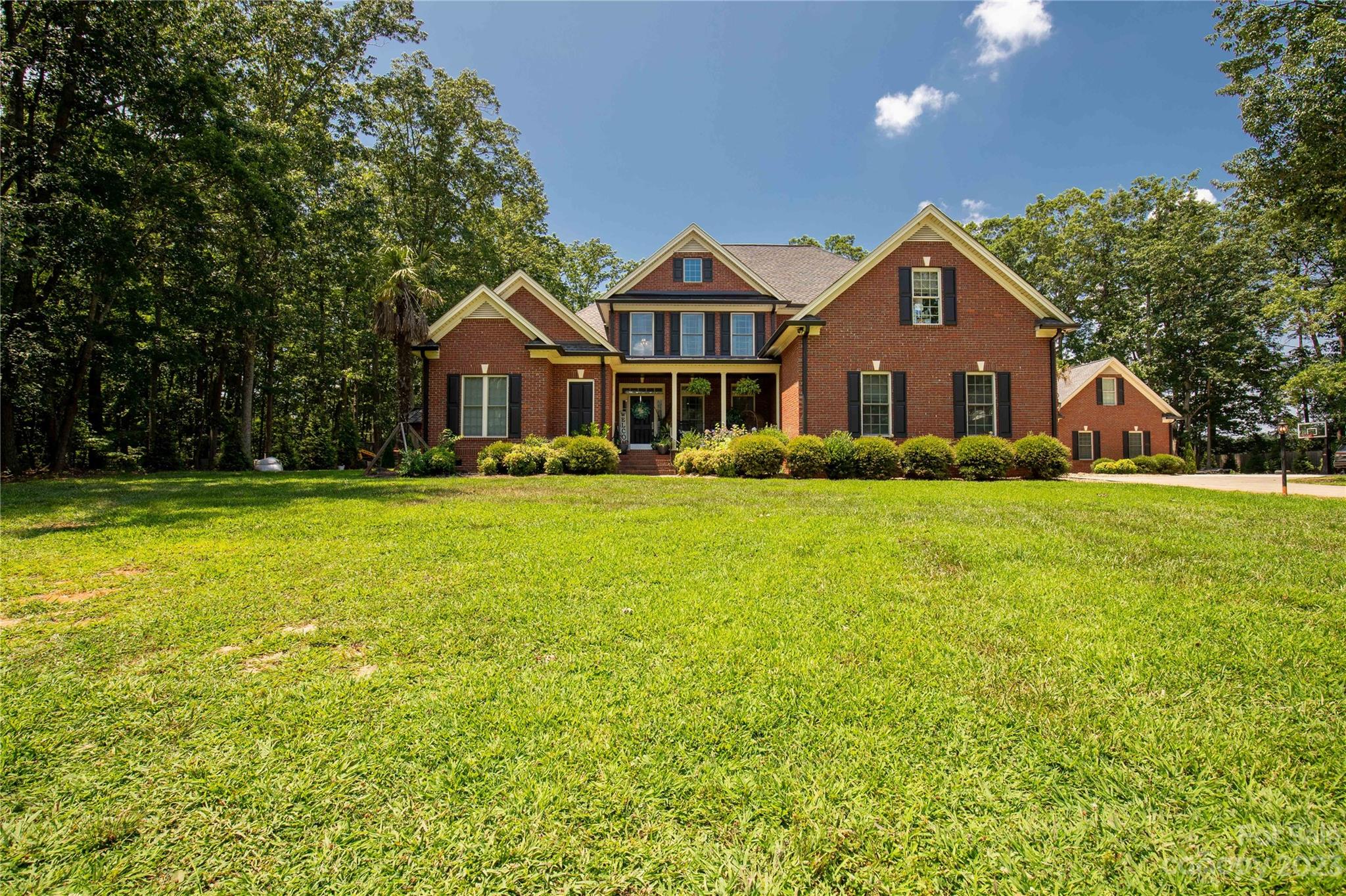 Welcome to your dream home nestled on a 2.33 acre lot in the award-winning Clover School District. This fully brick home offers newly remodeled features and luxurious amenities. Gated entry, entire property fenced in and Green Giant privacy trees lining the property. Prepare to entertain in your outdoor oasis consisting of a large saltwater pool w/spa and waterslide, covered back porch wired for tv, cedar pool cabana and gas fire pit. 1st floor consist of updated kitchen with large island, wet bar, modern light fixtures and fireplace, laundry room, great room with modern fireplace, formal dining room with upgraded light fixture, full bath for guest, expansive primary bedroom with tray ceiling that leads to the remodeled master bathroom and custom built closet with large island and vanity area. 2nd floor consist of 3 bedrooms, 2 remodeled baths, modern theater room with built-in wet bar. Detached garage with separate living quarters. Private, elegant & thoughtful at every turn!
