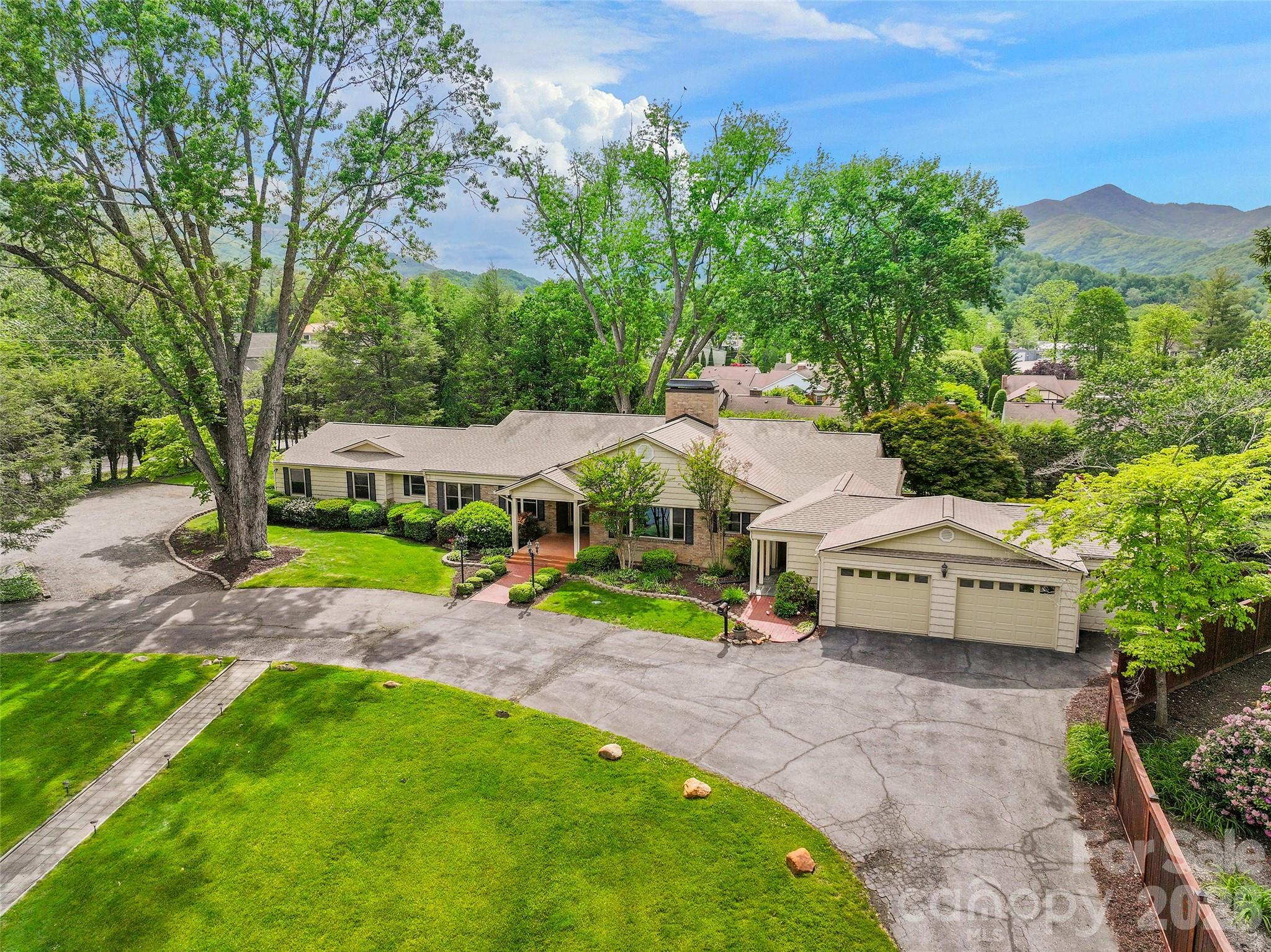 A rare find in the heart of Waynesville, this updated historic home offers space, comfort and strong investment potential. Located near the Waynesville Inn and Golf Club, the property is ideal for a large family, multigenerational living or short-term rental use.

Set on 1.047 acres, the home features a flat yard, mature landscaping, privacy fencing for pets, beautiful Balsam Mountain views and a peaceful creek. There is also space for an RV, with electric and water hookups already in place.

Inside, the main home offers a formal foyer, updated eat-in kitchen, butler’s pantry, formal dining room and a large wormy chestnut living room with a fireplace. The main level includes five spacious bedroom suites. The lower level has private guest quarters with a separate entrance, along with a large family room or recreation area with a gas fireplace.

Additional features include a golf cart garage, a large two-car garage and plenty of parking. The property also offers room to add another garage, guest quarters or rental cottages.

This is a unique Waynesville property with room to live, host, invest and enjoy the best of mountain living.