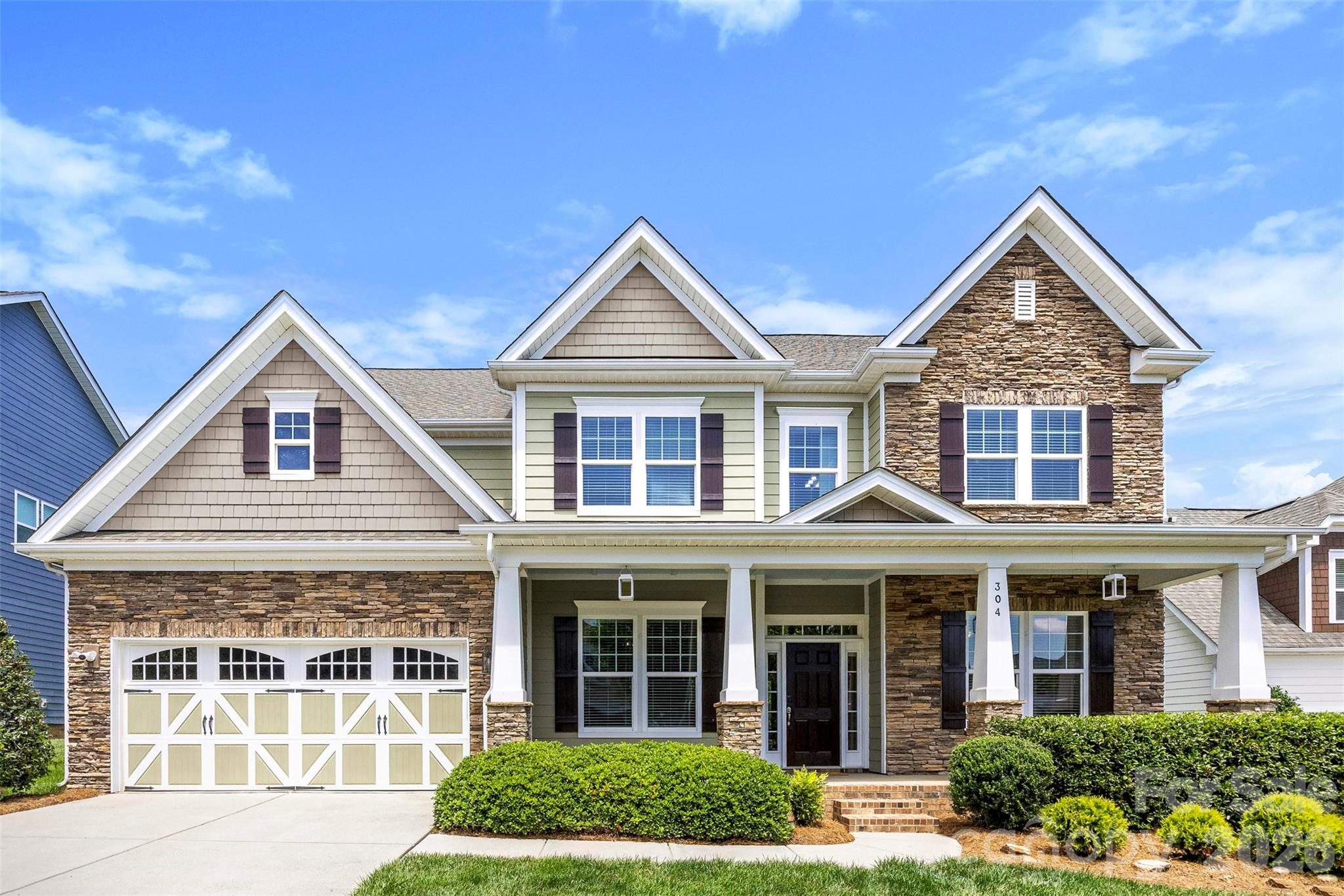 Welcome to one of MillBridge's most sought-after floor plans—the highly desirable Tremont model by Bonterra. Originally showcased as a model home, this impressive residence offers nearly 4,000 square feet of thoughtfully designed living space, exceptional upgrades, and the resort-style lifestyle that has made MillBridge one of the most desirable communities in the Carolinas.

From the moment you arrive, you'll be captivated by the home's stunning curb appeal, beautiful stone elevation, and dramatic oversized front porch that creates a grand and welcoming entrance rarely found in today's homes. Situated on a private, fully fenced homesite with professional landscaping, this meticulously maintained residence is truly move-in ready. Recent updates include fresh interior paint, brand-new carpet throughout, upgraded lighting, and beautifully maintained hardwood floors throughout the main living areas.

The open-concept floor plan is ideal for both everyday living and entertaining. The chef's kitchen features cream-colored staggered cabinetry, granite countertops, a large farmhouse sink, five-burner gas cooktop, wall ovens, spacious island, and abundant storage. The breakfast area is surrounded by windows and natural light, creating the perfect space to start your day. A formal dining room with designer lighting and an oversized private office with French doors provide both elegance and functionality.

The dramatic great room showcases an oversized fireplace, coffered ceilings, and expansive windows that flood the home with natural light. The main level also features a spacious guest suite with a full bath, offering privacy and convenience for visitors or multigenerational living.

Retreat to the luxurious primary suite featuring a cathedral ceiling, custom walk-in closet, and spa-inspired bath with upgraded finishes designed for relaxation. Upstairs you'll find generously sized secondary bedrooms, including a Jack-and-Jill bath configuration, along with a large recreation/media room complete with projector screen, in-wall speakers, and media equipment that conveys with the home.

Step outside and discover one of the home's most impressive features—an oversized custom patio designed for entertaining, relaxing, and enjoying the private backyard setting. Whether hosting gatherings with friends and family or enjoying a quiet evening outdoors, this exceptional outdoor living space extends the home's functionality and appeal.

Additional highlights include an oversized garage, in-ground irrigation system, refrigerator, washer, and dryer included, and exceptional pride of ownership throughout.

Beyond the home, enjoy MillBridge's award-winning resort-style amenities, including multiple pools, a three-story waterslide, fitness center, clubhouse, coffee bar, movie theater, tennis courts, putting green, walking trails, playgrounds, recreation areas, and a year-round calendar filled with social events and activities for all ages.

This is more than a home—it's a lifestyle.