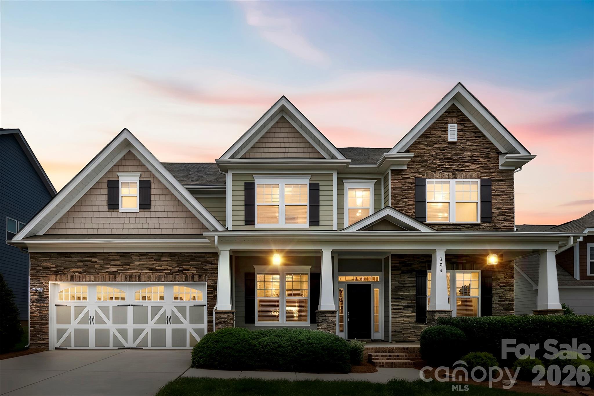 Welcome to one of MillBridge's most sought-after floor plans—the highly desirable Tremont model by Bonterra. Originally showcased as a model home, this impressive residence offers nearly 4,000 square feet of thoughtfully designed living space, exceptional upgrades, and the resort-style lifestyle that has made MillBridge one of the most desirable communities in the Carolinas.

From the moment you arrive, you'll be captivated by the home's stunning curb appeal, beautiful stone elevation, and dramatic oversized front porch that creates a grand and welcoming entrance rarely found in today's homes. Situated on a private, fully fenced homesite with professional landscaping, this meticulously maintained residence is truly move-in ready. Recent updates include fresh interior paint, brand-new carpet throughout, upgraded lighting, and beautifully maintained hardwood floors throughout the main living areas.

The open-concept floor plan is ideal for both everyday living and entertaining. The chef's kitchen features cream-colored staggered cabinetry, granite countertops, a large farmhouse sink, five-burner gas cooktop, wall ovens, spacious island, and abundant storage. The breakfast area is surrounded by windows and natural light, creating the perfect space to start your day. A formal dining room with designer lighting and an oversized private office with French doors provide both elegance and functionality.

The dramatic great room showcases an oversized fireplace, coffered ceilings, and expansive windows that flood the home with natural light. The main level also features a spacious guest suite with a full bath, offering privacy and convenience for visitors or multigenerational living.

Retreat to the luxurious primary suite featuring a cathedral ceiling, custom walk-in closet, and spa-inspired bath with upgraded finishes designed for relaxation. Upstairs you'll find generously sized secondary bedrooms, including a Jack-and-Jill bath configuration, along with a large recreation/media room complete with projector screen, in-wall speakers, and media equipment that conveys with the home.

Step outside and discover one of the home's most impressive features—an oversized custom patio designed for entertaining, relaxing, and enjoying the private backyard setting. Whether hosting gatherings with friends and family or enjoying a quiet evening outdoors, this exceptional outdoor living space extends the home's functionality and appeal.

Additional highlights include an oversized garage, in-ground irrigation system, refrigerator, washer, and dryer included, and exceptional pride of ownership throughout.

Beyond the home, enjoy MillBridge's award-winning resort-style amenities, including multiple pools, a three-story waterslide, fitness center, clubhouse, coffee bar, movie theater, tennis courts, putting green, walking trails, playgrounds, recreation areas, and a year-round calendar filled with social events and activities for all ages.

This is more than a home—it's a lifestyle.