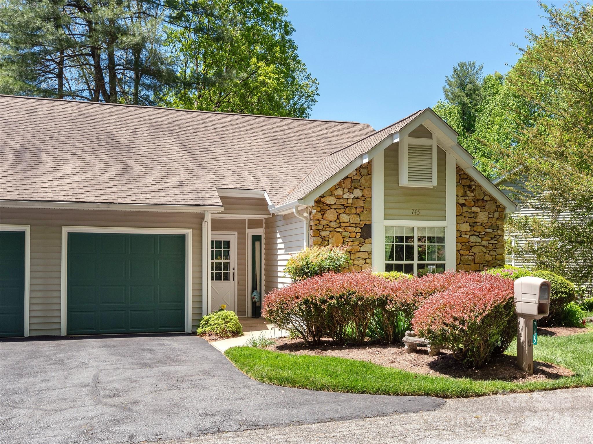 A Lovely Mountain View from this light and airy townhome in Laurel Park! Enjoy carefree living where you are just minutes to Historic Main Street, services and recreation. Features of this home include a great room with gleaming hardwood floor, vaulted ceiling and fireplace plus access to the screened porch, The spacious kitchen has granite counters, wood floor and pantry, inviting primary suite with two closets and bath, a second bedroom on the main level plus a full bath, the lower level is highlighted with a family/game room, bedroom and third full bath and sliding glass door to a screened porch! One car garage and more!