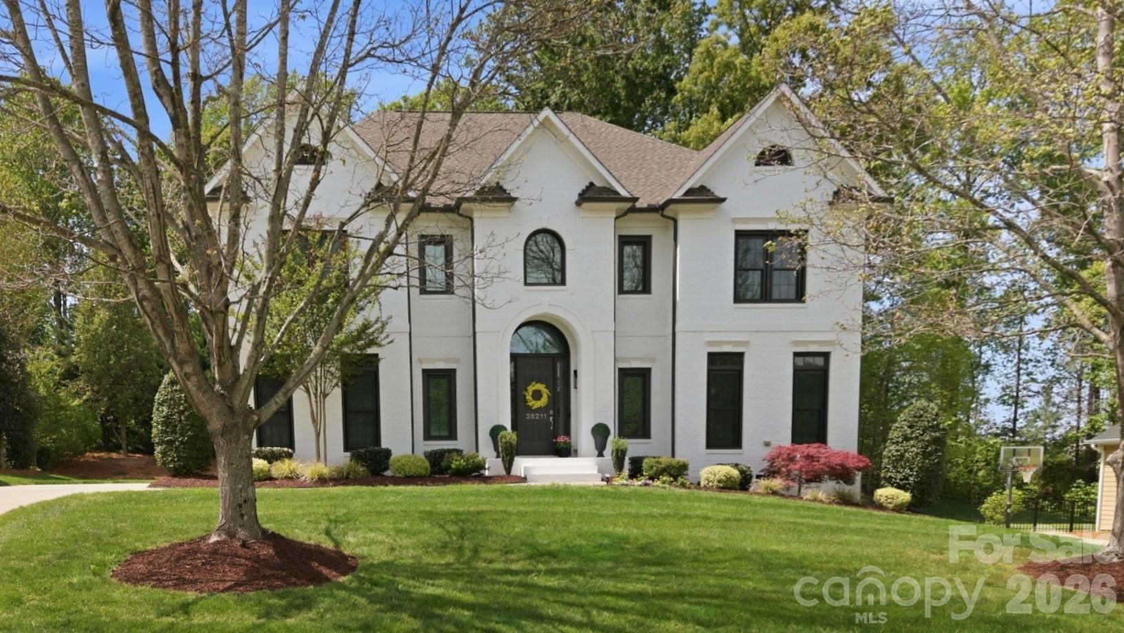 Meticulously maintained and showing like a model, this stunning and highly sought-after John Weiland Windsor plan w/3-car side load garage in desirable Bridgehampton offers the perfect blend of elegance, comfort, and lifestyle. Recent updates include new windows, enhancing both efficiency and natural light throughout.

The grand foyer makes an immediate impression, showcasing rich hardwood floors and setting the tone for the home’s timeless design. The open floorplan flows effortlessly from room to room—ideal for both everyday living and entertaining. The kitchen offers abundant storage and a generous island that serves as the heart of the home, perfect for gathering, prepping, and creating memorable meals.

The 2-story great room features stunning architectural detail and expansive picture windows that flood the space with natural light while bringing the outdoors in. A gas fireplace adds warmth and charm, creating a cozy atmosphere on cooler evenings.

Enjoy breathtaking sunsets from the comfort of your sofa, patio, or the charming side porch—an inviting retreat that quickly becomes a favorite spot. Whether starting your day with coffee or unwinding with a glass of wine or sweet tea, this peaceful outdoor space is perfect for relaxing and recharging.

Step outside to a truly special backyard setting featuring a huge patio and a gorgeous 14x10 pergola draped with twinkling market lights—an ideal space for entertaining, dining al fresco, or simply enjoying quiet evenings under the stars.

Set on a private .37-acre homesite backing to woods, this property offers both tranquility and space, with plenty of room to add a pool and create your own backyard oasis.

Upstairs, the second level offers four spacious bedrooms, each with en suite or Jack-and-Jill baths, providing comfort and privacy. The expansive primary suite is a true retreat, featuring a beautifully updated, spa-like bath with an oversized shower and freestanding soaking tub—perfect for unwinding after a long day or even a long tennis match. Just beyond, you’ll find two walk-in closets and a versatile flex space currently used as a home office.

The third floor provides exceptional flexibility with a large recreation room or fifth bedroom, along with a generous unfinished storage area.

This home is located in one of Charlotte’s most welcoming and amenity-rich communities and you can even walk to the pool and clubhouse. Residents enjoy a true resort lifestyle featuring a spectacular pool with a large spiral water slide and splash pad, tennis and pickleball courts, a clubhouse with fitness center, playground, basketball courts, and scenic walking trails.

Ideally situated just 2.4 miles or about a 10-minute drive from the Ballantyne Bowl, you’ll enjoy easy access to a vibrant mix of restaurants, shops, and a beautiful park. This location offers the best of both worlds—a Ballantyne location and lifestyle at a SC price point and low taxes.

Neighbors truly connect and enjoy an active social calendar in Bridgehampton, making this not just a home, but a lifestyle you’ll love.