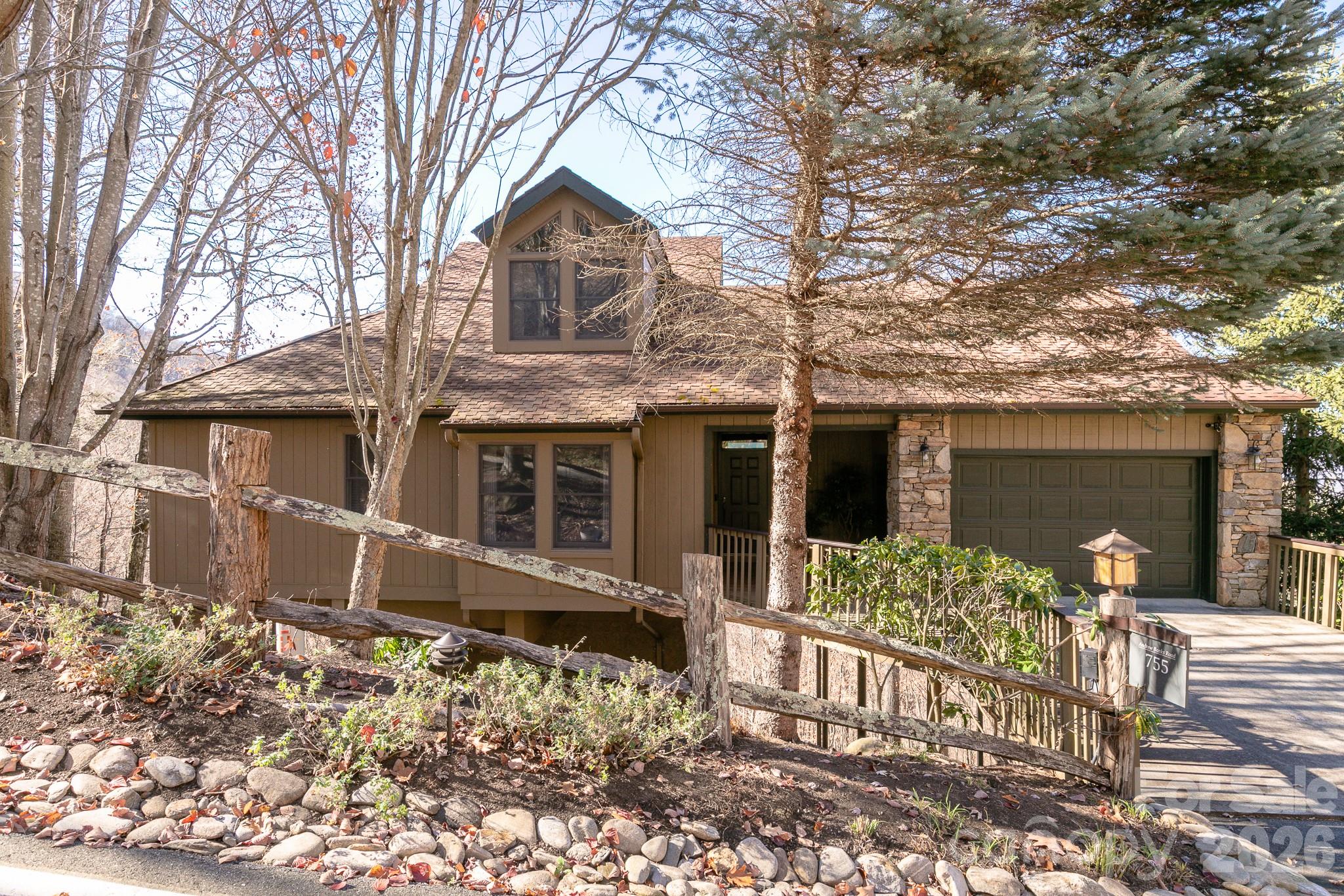 Gorgeous long-range mountain views and an Old-Growth Forest setting surround this fully furnished MOUNTAIN AIR, single-family retreat. Designed for comfortable mountain living, the open floor plan features a main-level guest suite and a spacious primary suite with a walk-in closet, soaking tub, and separate shower. The great room showcases a floor-to-ceiling stone fireplace and a wall of tinted windows with custom motorized blinds that frame the breathtaking views. The open kitchen is equipped with newer appliances, including a range, gas cooktop, microwave, and washer/dryer. Enjoy cool summer temperatures from the screened porch, complete with a Viking outdoor kitchen and an all-weather television with enhanced brightness for outdoor viewing. Upstairs, a versatile bonus area offers endless possibilities as a home office, reading nook, additional gathering space, or fourth bedroom suite. The space currently features a 75-inch 8K television, making it ideal for game days and movie nights. The lower level includes a spacious bedroom with an en-suite bath and direct access to the lower deck, providing privacy and comfort for guests. The garage accommodates both a vehicle and a golf cart. Golf cart is negotiable outside of closing. You are close to the Golf Learning Center and hiking trails, with a convenient golf cart path nearby for easy access to the club amenities, available with separate membership.