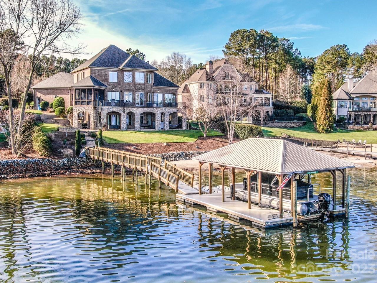 Welcome home to Lake Norman! Amazing main channel views, quality construction and materials throughout.  Thoughtful layout and meticulously maintained home in desirable Northview Harbour.

This home boasts a full brick and stone exterior, beautiful 2 story great room with a stone fireplace from floor to ceiling and open concept living. The kitchen offers abundant cabinet space, spacious island, walk in pantry and new gas cook top.

The Fully finished walkout lower level feels like another entire home with its 11 ft ceilings, full kitchen, bedroom, bathroom, living and dining areas as well as 3 large storage areas.

The outdoor living space includes the screened porch, full main level balcony, full covered lower-level patio with fire pit area, wonderful sandy beach and a covered boat house with lift.

The Northview Harbour Community features a pool, tennis courts, clubhouse, nature trail, dry boat storage, community boat ramp, and playground.