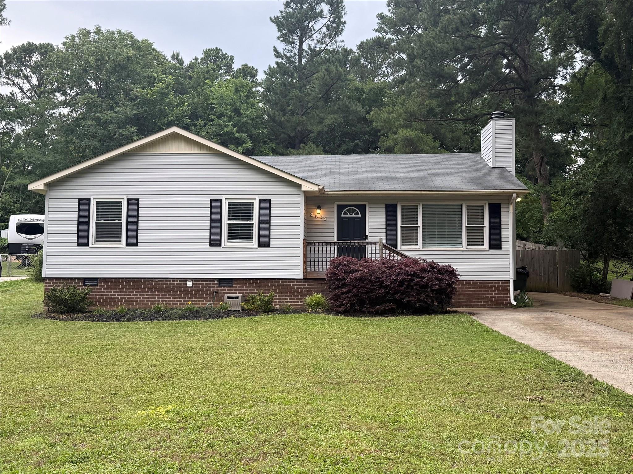 This beautifully remodeled ranch-style home is located minutes from I-77 and a short drive to Charlotte. Nestled on a nicely landscaped lot with a fenced backyard, this 3-bedroom, 2-bathroom gem offers the perfect blend of modern upgrades and one-level living. Enjoy relaxing on the back porch or entertaining in the spacious open floor plan featuring a cathedral ceiling and gas fireplace. State-of-the-art kitchen with granite countertops, soft-close cabinetry, and top-tier appliances. Gorgeous hardwood bamboo flooring and plush carpet. The swing-set does not convey. This home has great bones and tons of potential for the right buyer with vision. With a little TLC, it can truly shine! Whether you're looking for a smart investment or a place to make your own, this property is a fantastic opportunity. Motivated sellers – bring your offers!