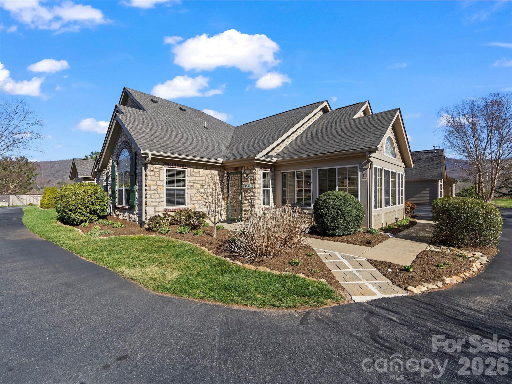 Experience the perfect blend of comfort and scenery at 81 Outlook Circle, located in the desirable Craggy View Cottages. This 1,544 sq. ft. one-level townhouse features an open floor plan that seamlessly connects the kitchen and dining area to a spacious living room centered around a cozy corner fireplace. A versatile sunroom provides additional living space tailored to your needs—whether as an elegant dining room, a quiet den, or a sunny home office. Relax on your private front patio, a perfect spot for quiet evenings in a serene setting. Throughout the
community, you'll enjoy breathtaking year-round mountain views and meticulously landscaped grounds. The home also includes a large double garage for ample storage and parking. Residents enjoy premium amenities, including a swimming pool and a clubhouse with a library. Perfectly situated between Asheville and Black Mountain, this home offers a quiet retreat with unbeatable access to the best of Western North Carolina.