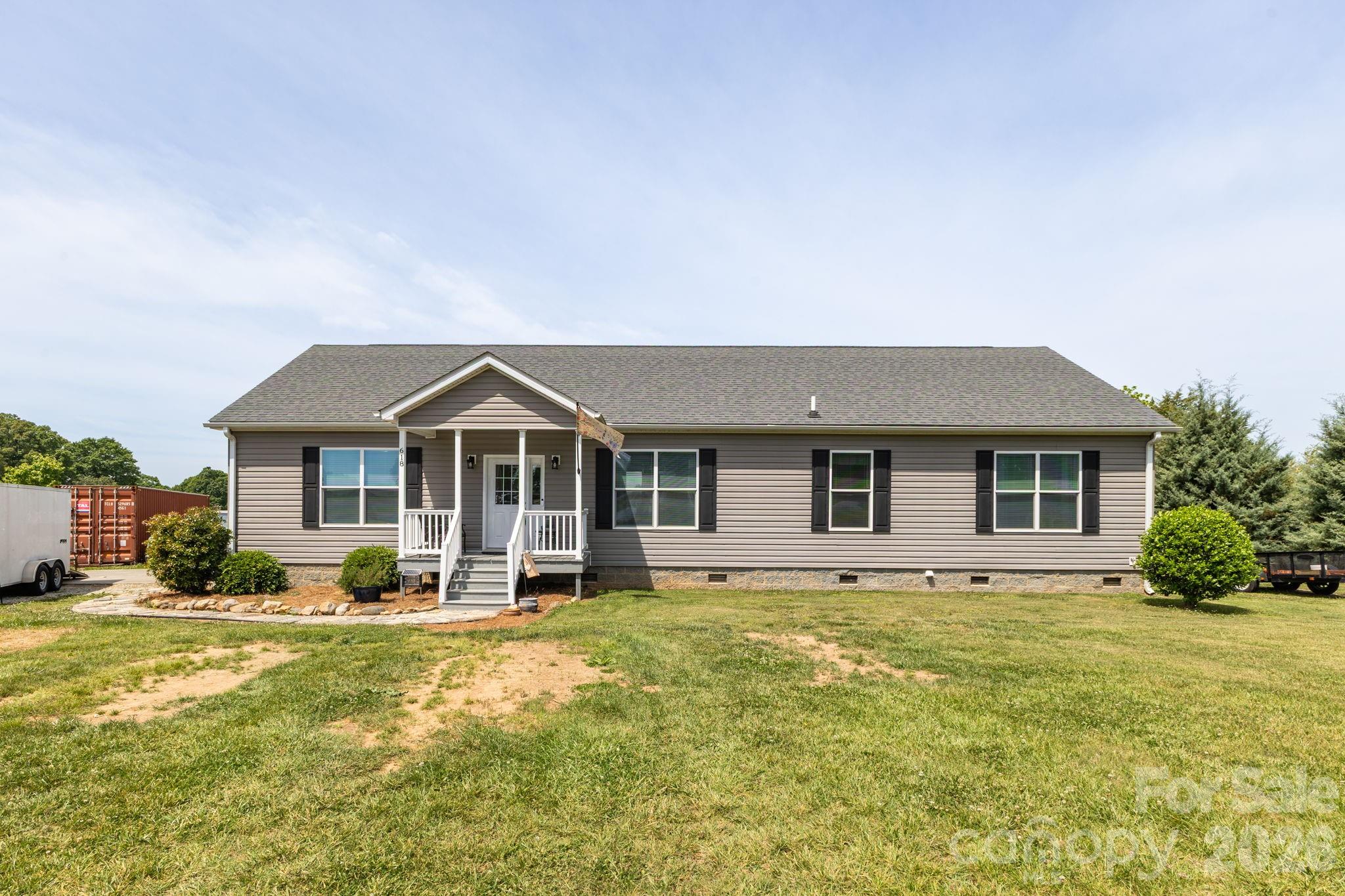 Welcome home to a chapter where modern comfort and country living come together in the Cool Springs area. Built in 2017, this well-maintained home was designed for gathering, slowing down, and enjoying the moments that matter most. The open-concept layout allows the kitchen and living area to flow together with ease, while the dining room’s coffee and wine bar, complete with a wine refrigerator creates a space ready for morning routines and evening conversations alike. The primary suite offers a bath with walk-in shower, while two additional bedrooms provide flexibility for guests, hobbies, or a home office. A laundry room with utility sink adds everyday convenience. Outside, the patio with a pergola and string lights invites evenings under the stars. The additional building with its own rocking chair front porch offers space for creativity, storage, or new possibilities. At 618 Society Road, every space feels ready for the next chapter of your story.