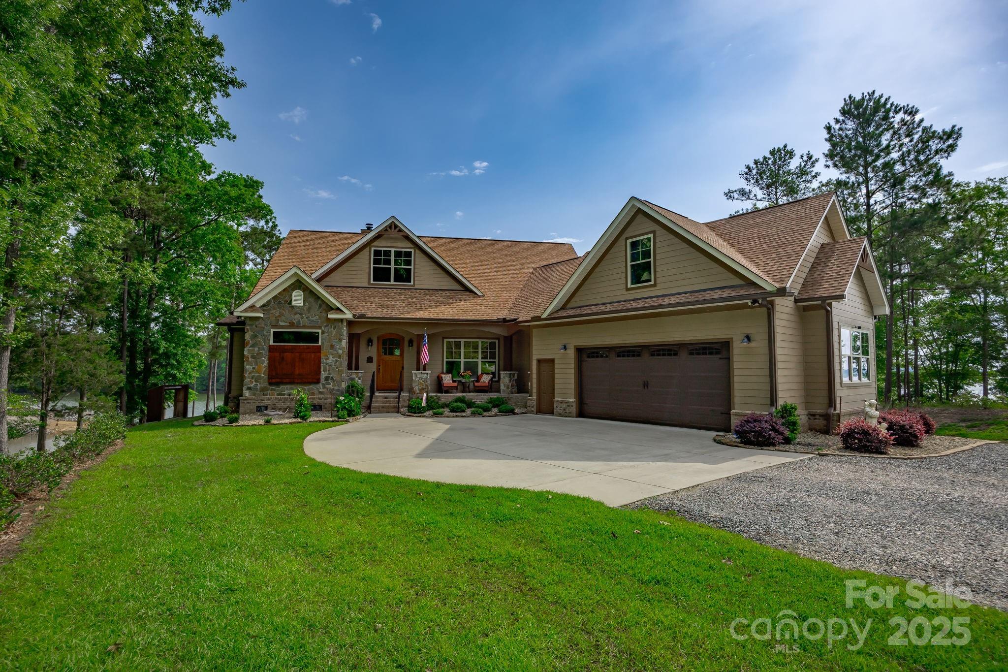 This modern craftsman home built in 2021 is everything you could want in a lake residence. Within the beautiful gated community of The Woods of Molly Creek, this home sits on almost 1.5 acres with a perfectly sloped lot out of the flood zone and offers very deep water with a new dock, boat lift, and big water views. The open FP offers primary level living space with all the extras like a large pantry, utility/laundry, office area and a spacious kitchen and great room with vaulted ceilings, fireplace and a designated dining area. The home features high quality finishes and has beautiful oak wood floors, custom cabinetry with granite, huge his and hers walk in closets and an enormous walk in shower. A paved parking area and double attached garage add to the convenience of this move in ready home. The lawn is landscaped perfectly and equipped with irrigation. Have a seat on the covered porch, take a deep breath, watch the fishing boats putter by and see why lake life is the best life.